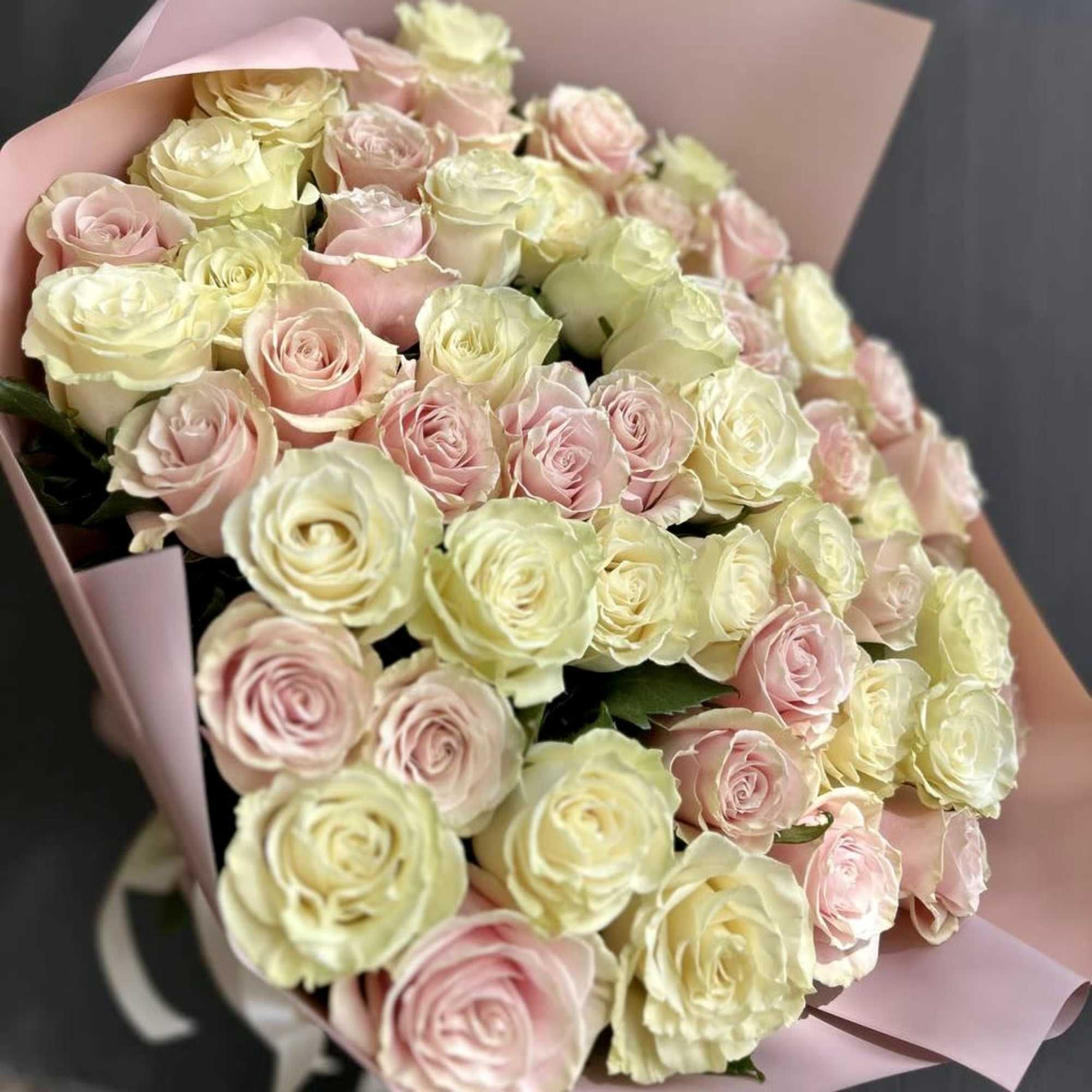 25 pink roses and 25 white roses are mixed to create a