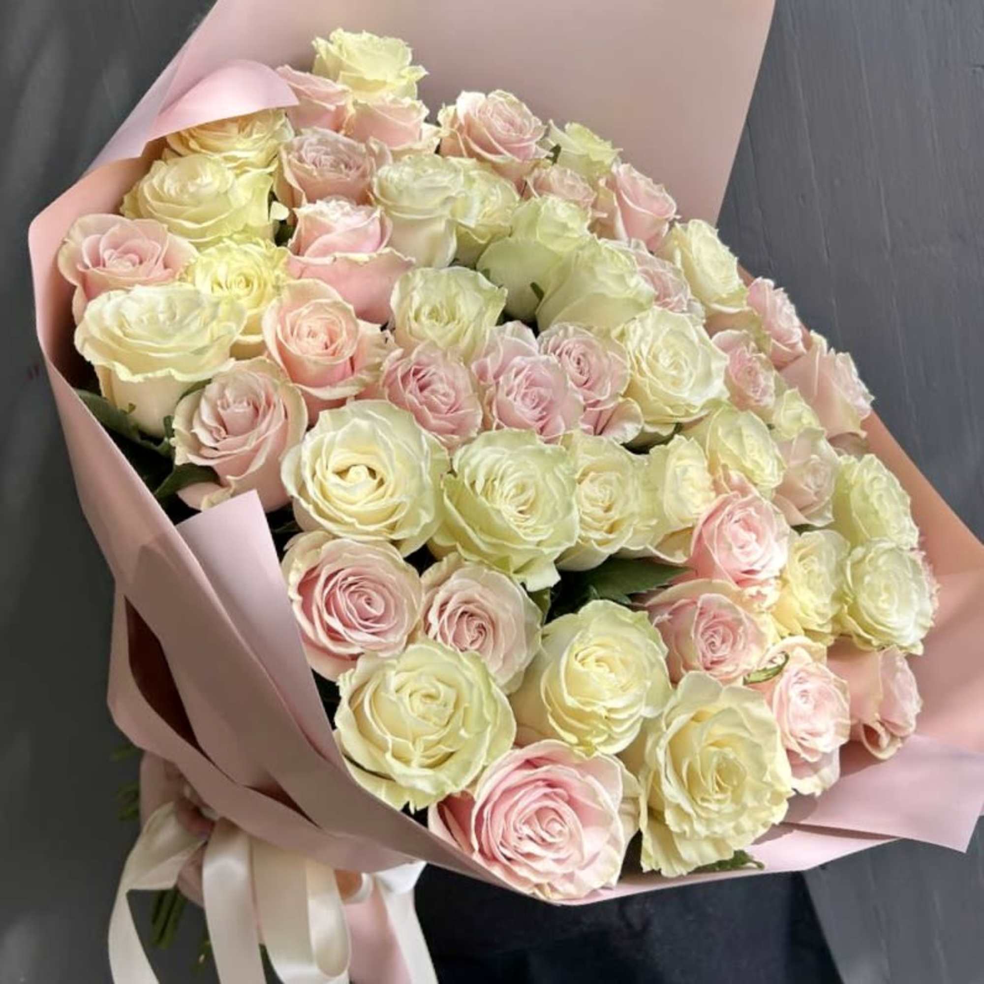 25 pink roses and 25 white roses are mixed to create a