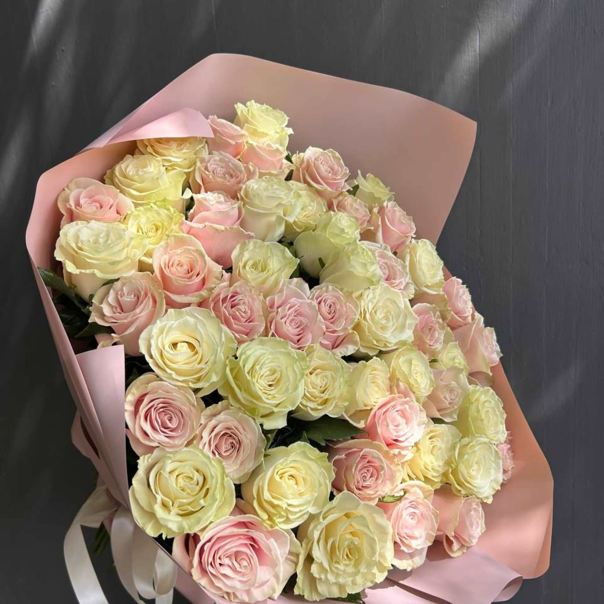 25 pink roses and 25 white roses are mixed to create a