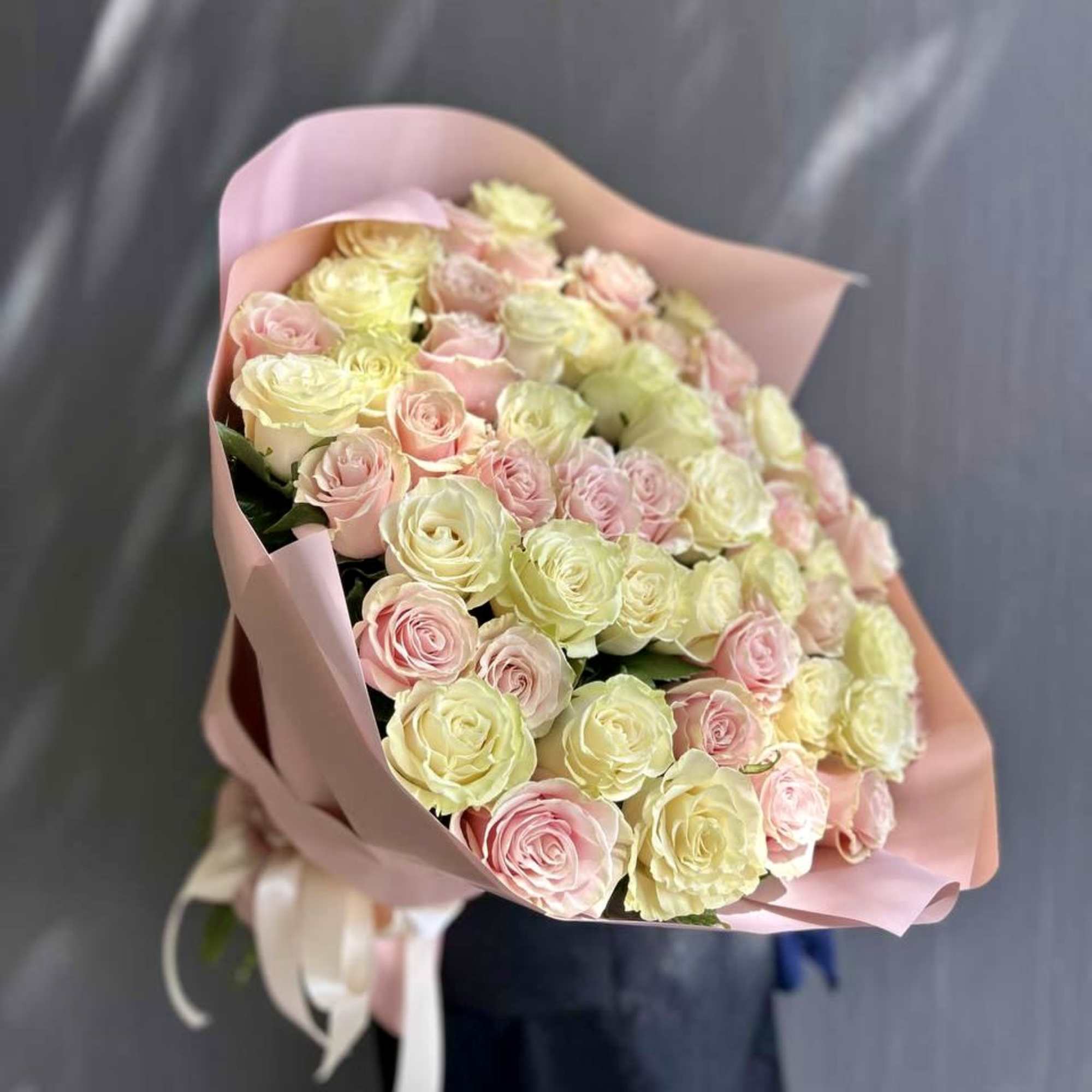 25 pink roses and 25 white roses are mixed to create a