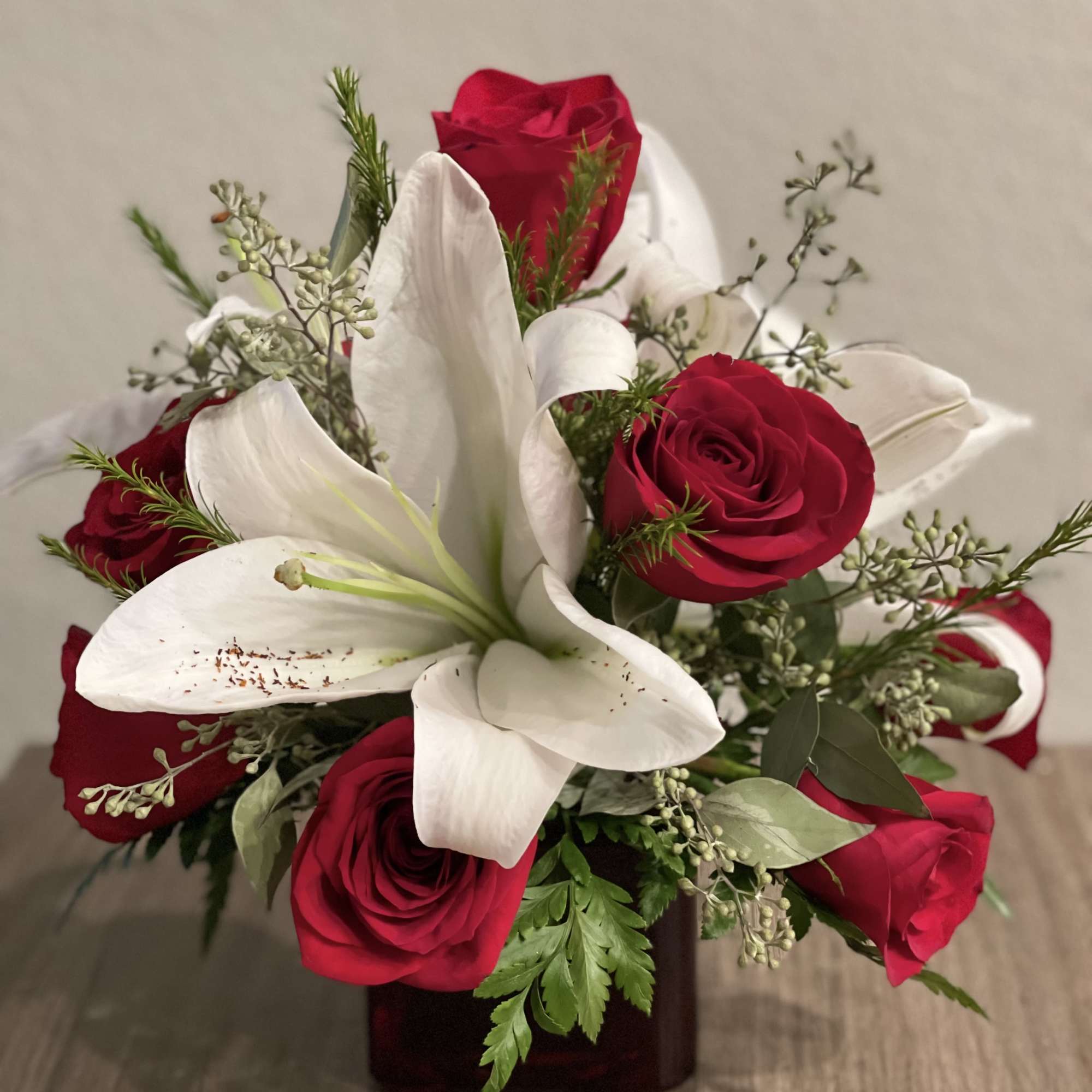 Cheerful floral arrangement of  red premium roses, white Asiatic lilies and