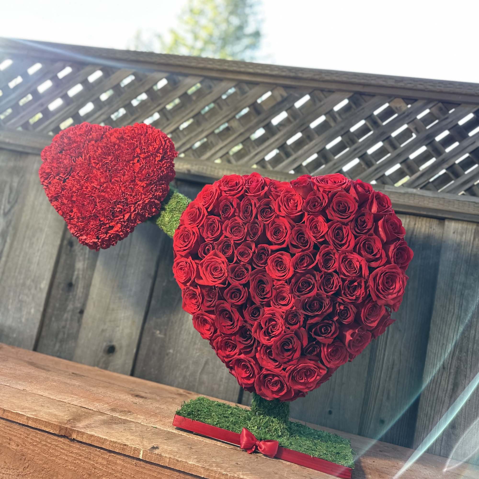 100 Red Roses Standing Arrangement by Pretty Petals Arrangements

Elevate any occasion with