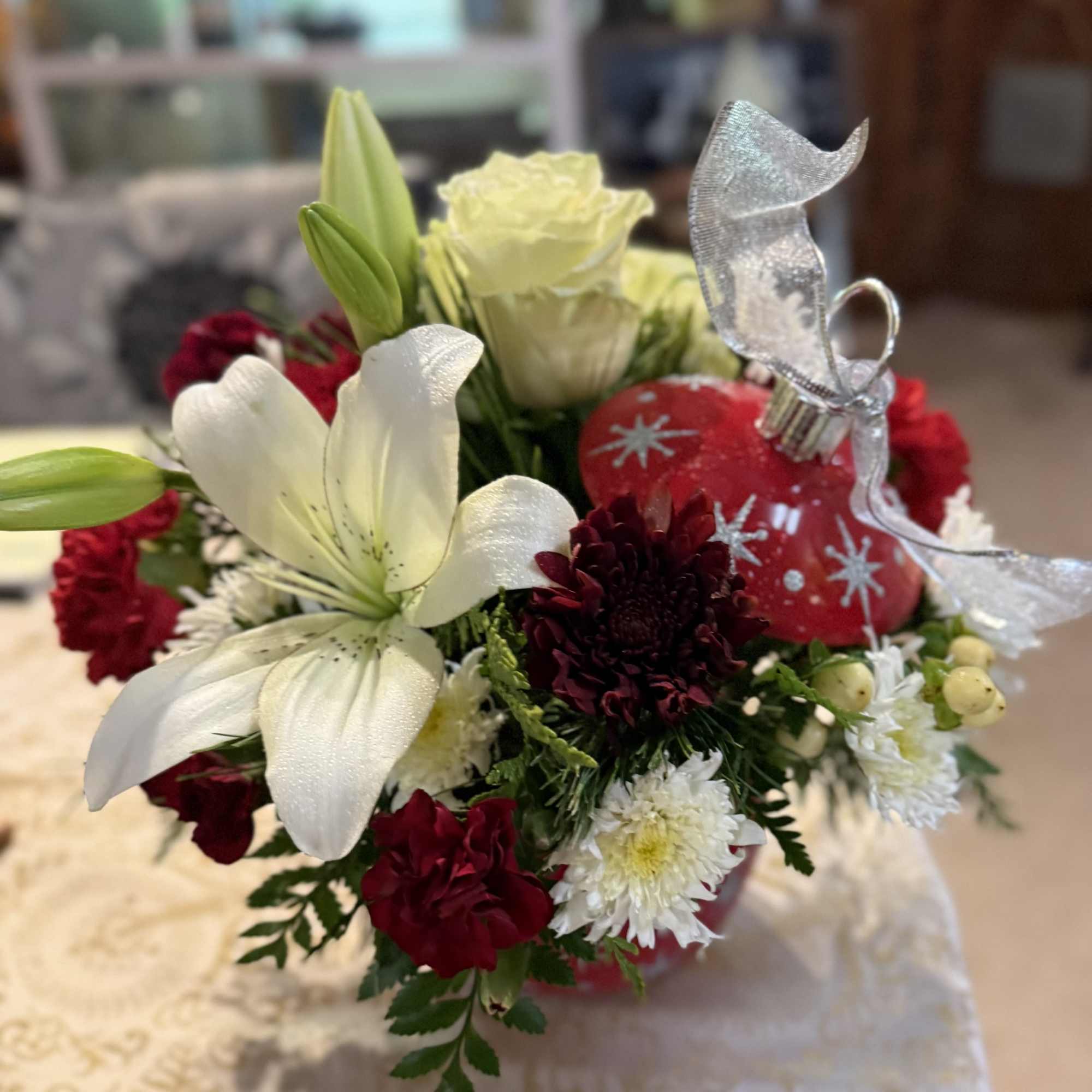 Fresh variety of festive Holiday colored flowers and Christmas greenery in a