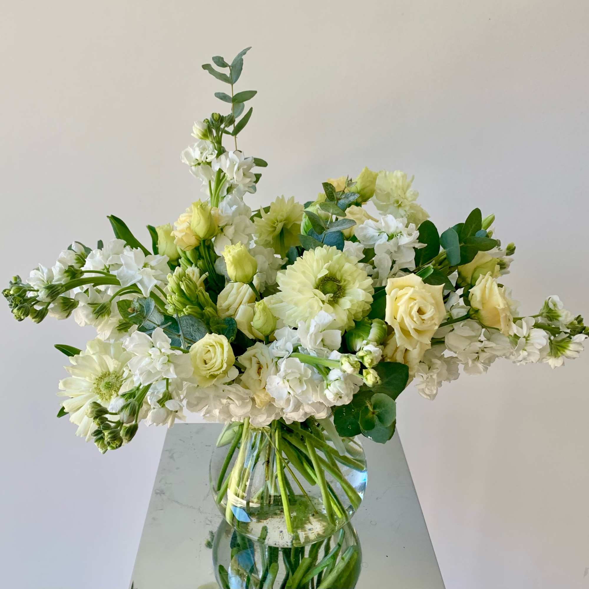 A lovely flower arrangement in neutral white and creamy yellow color tones