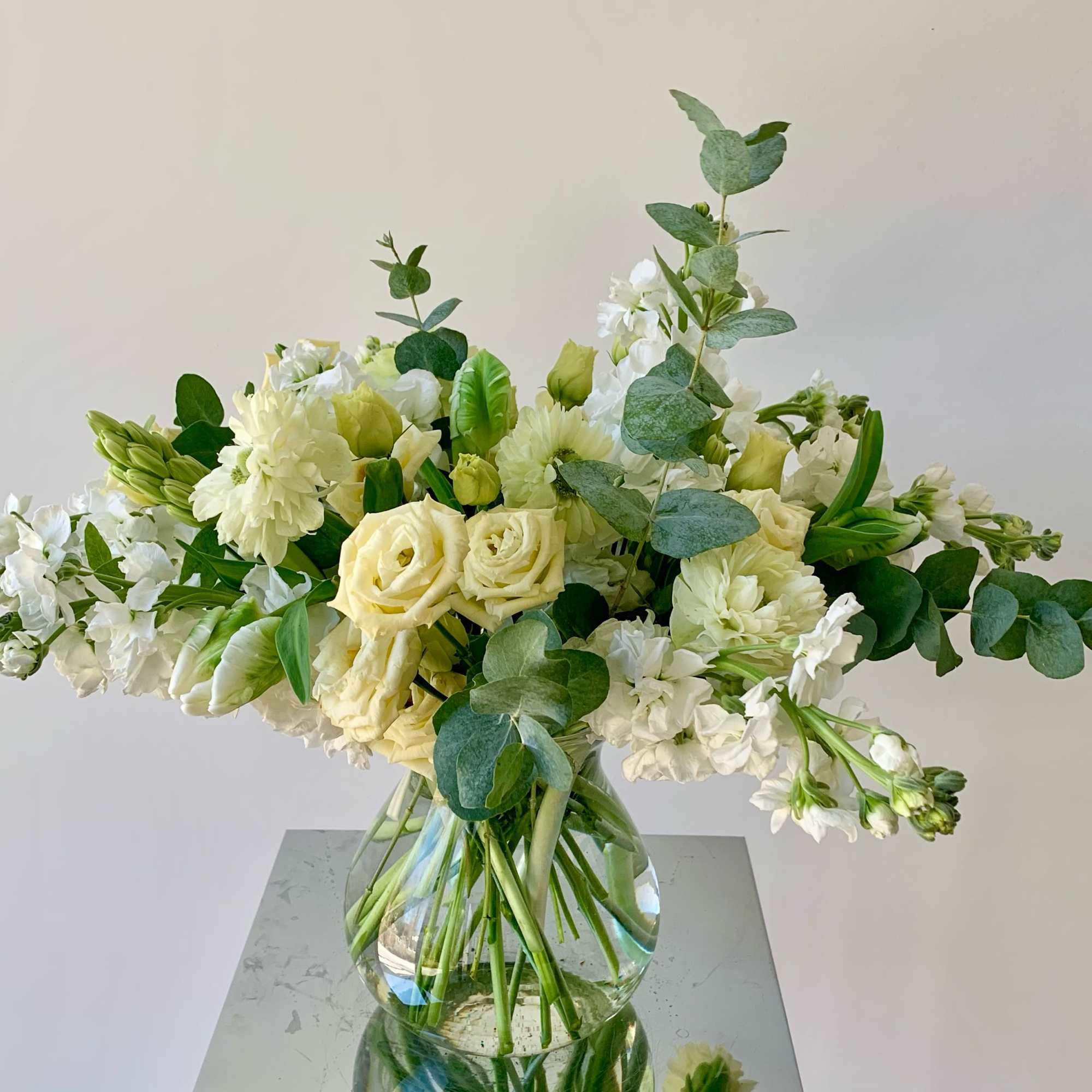 A lovely flower arrangement in neutral white and creamy yellow color tones