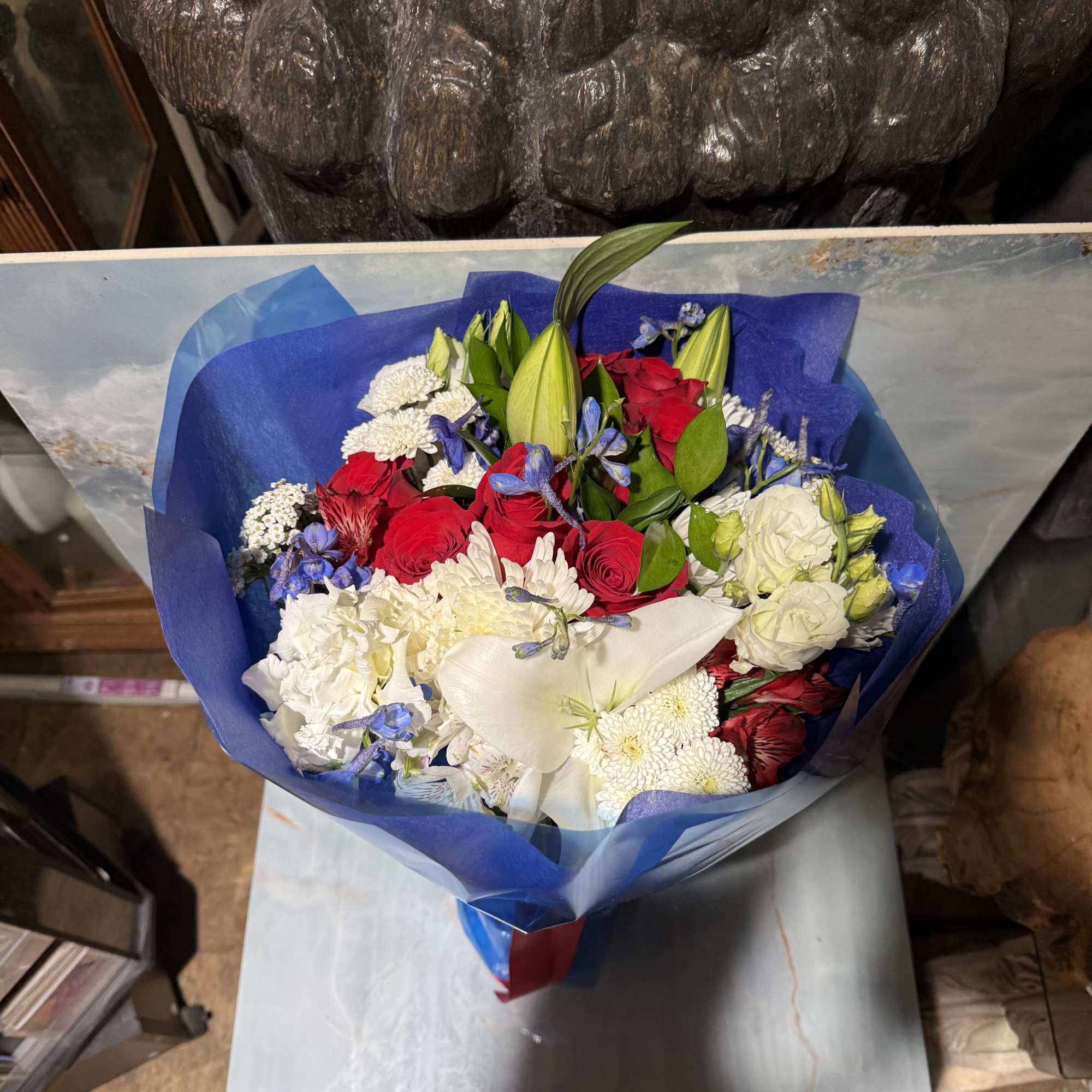 This is a classic red, white, and blue hand-tied bouquet with a
