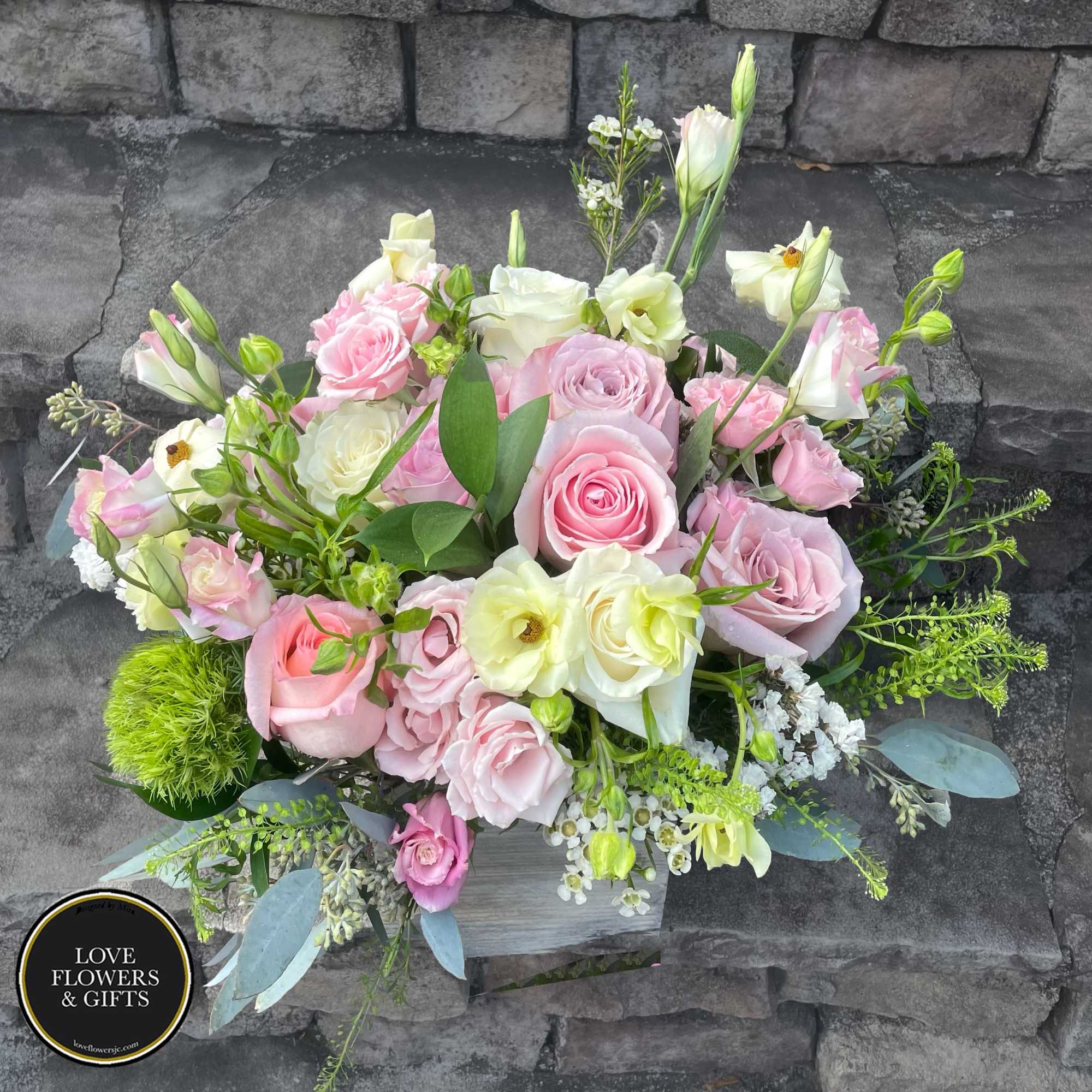 A beautiful and natural arrangement of soft and pale pinks and creams