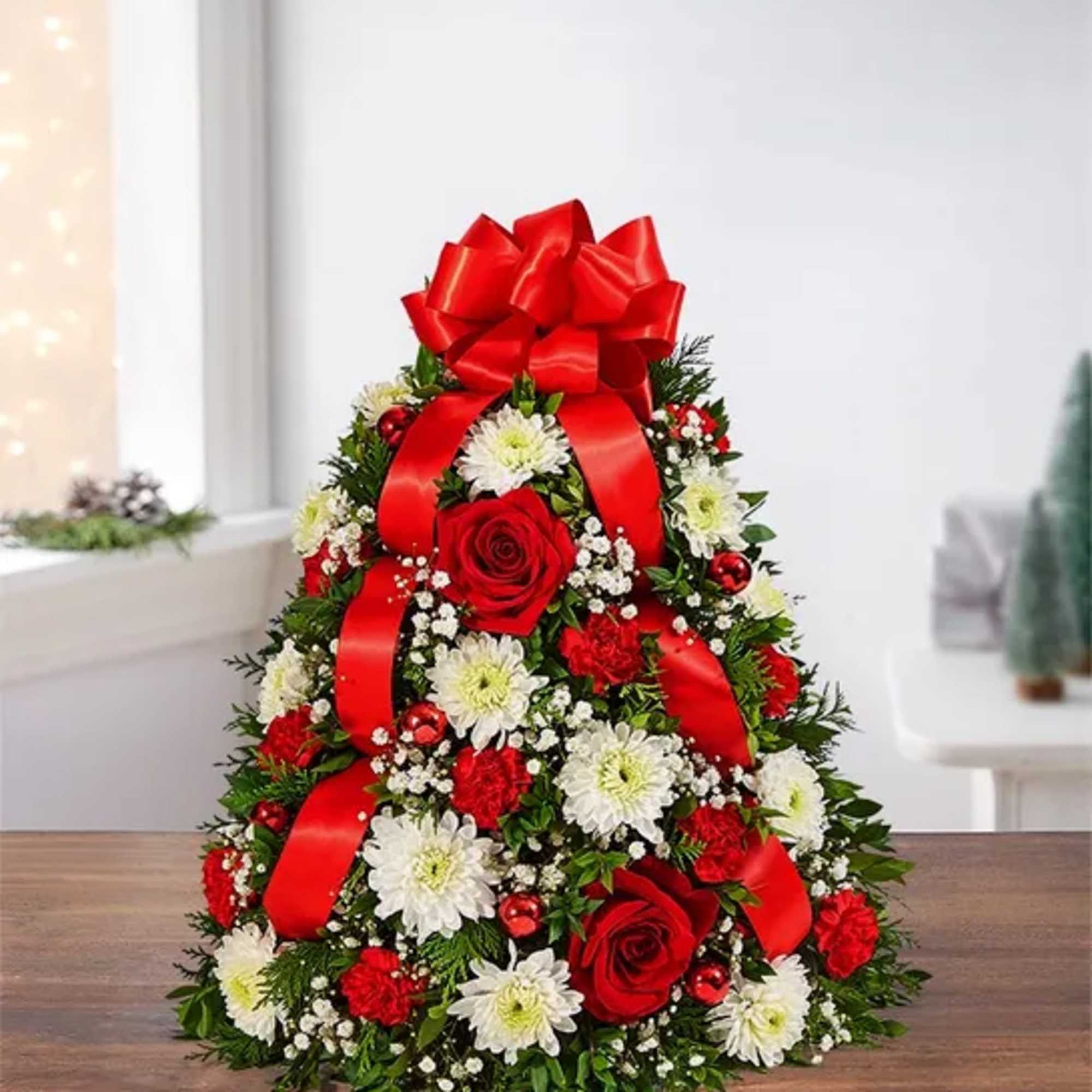 Boxwood and Christmas green Tree with fresh flowers on a low dish