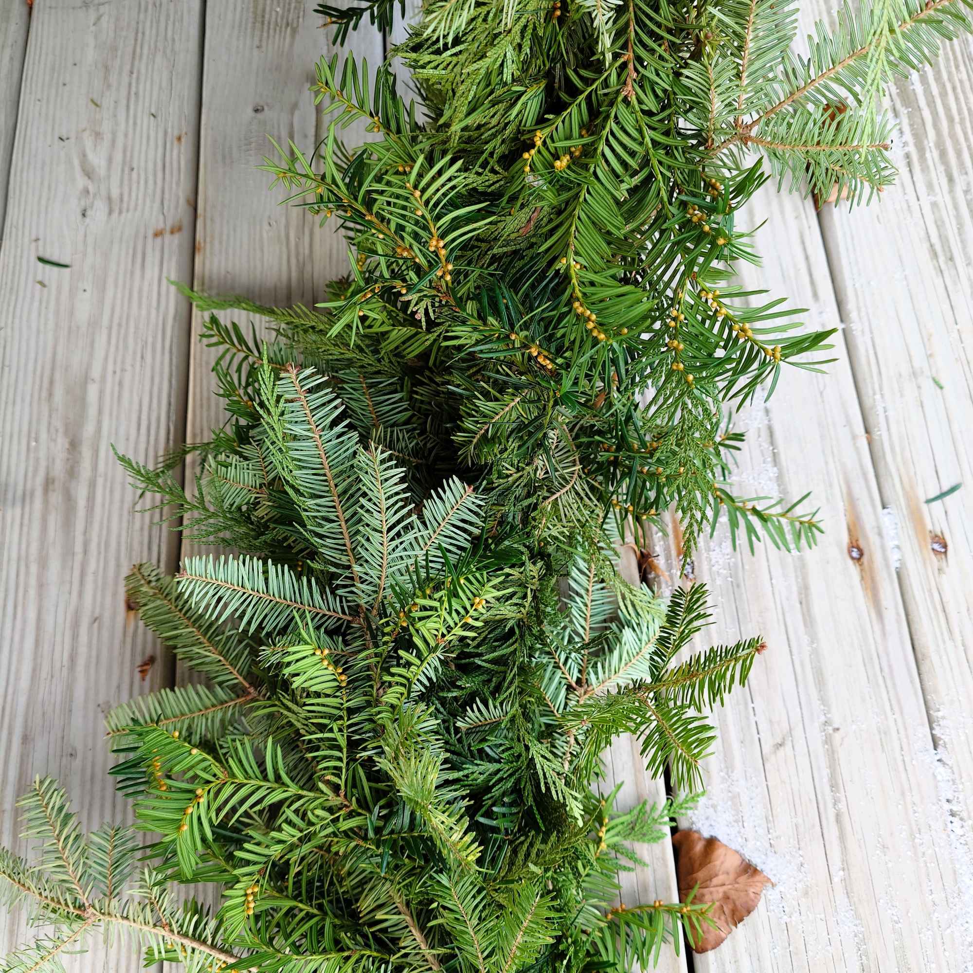 Our handcrafted evergreen garland is made fresh to order using a seasonal