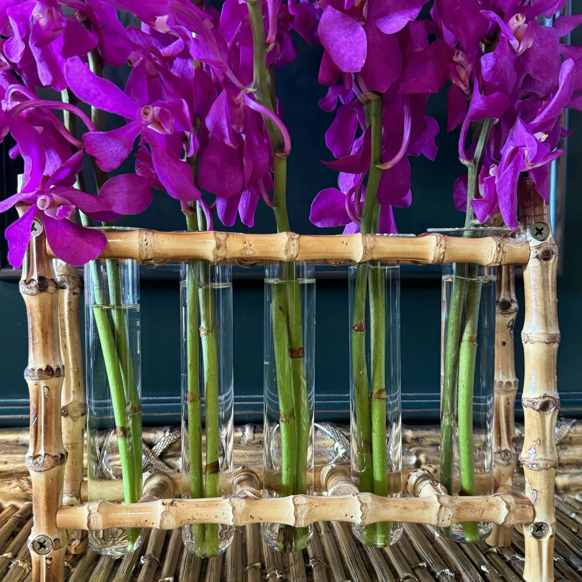 Bamboo Beauty is an elegant and striking arrangement featuring Makara orchids arranged