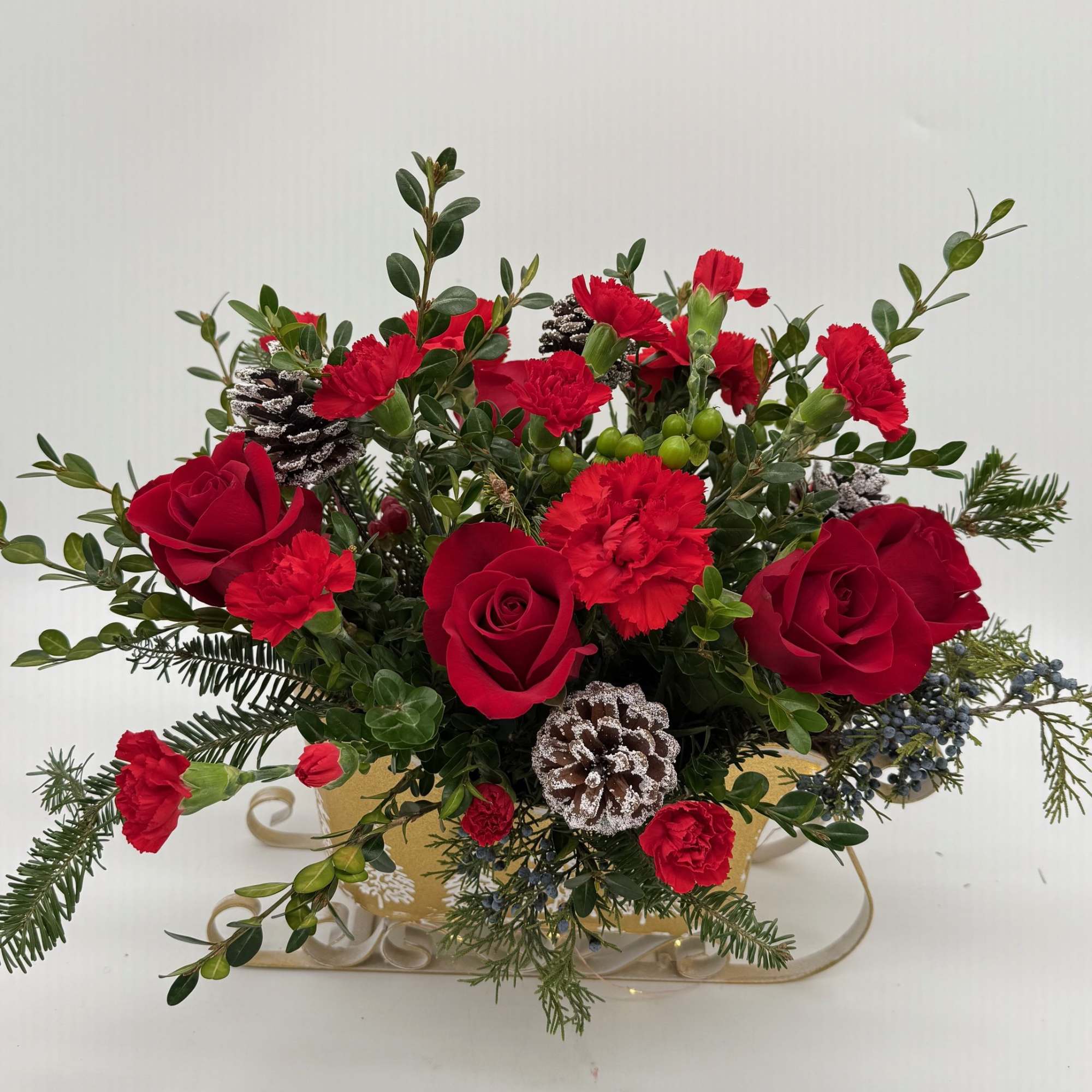 Sleigh the Holidays is packed with rich red blooms, fresh winter greenery