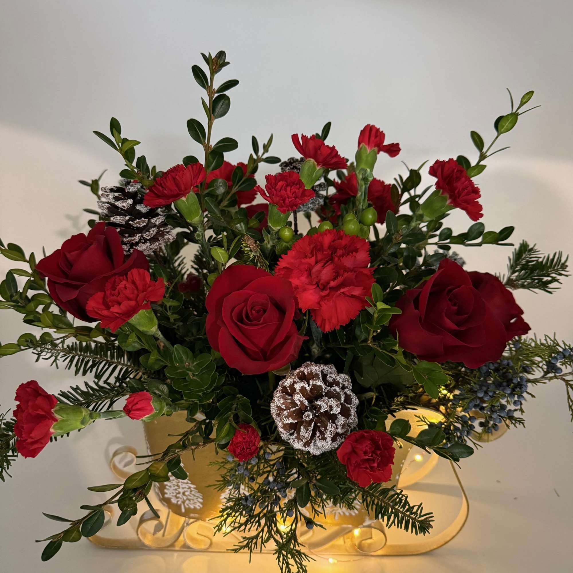 Sleigh the Holidays is packed with rich red blooms, fresh winter greenery