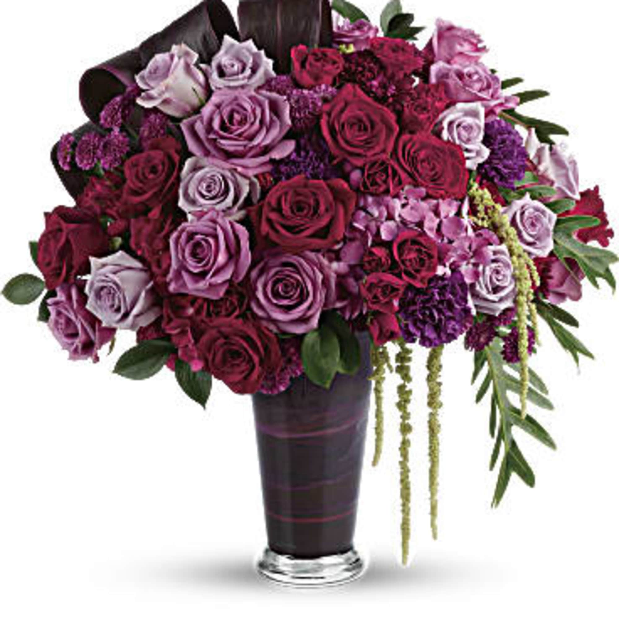 A dramatic display in jewel-toned roses and hydrangea in a sophisticated vase