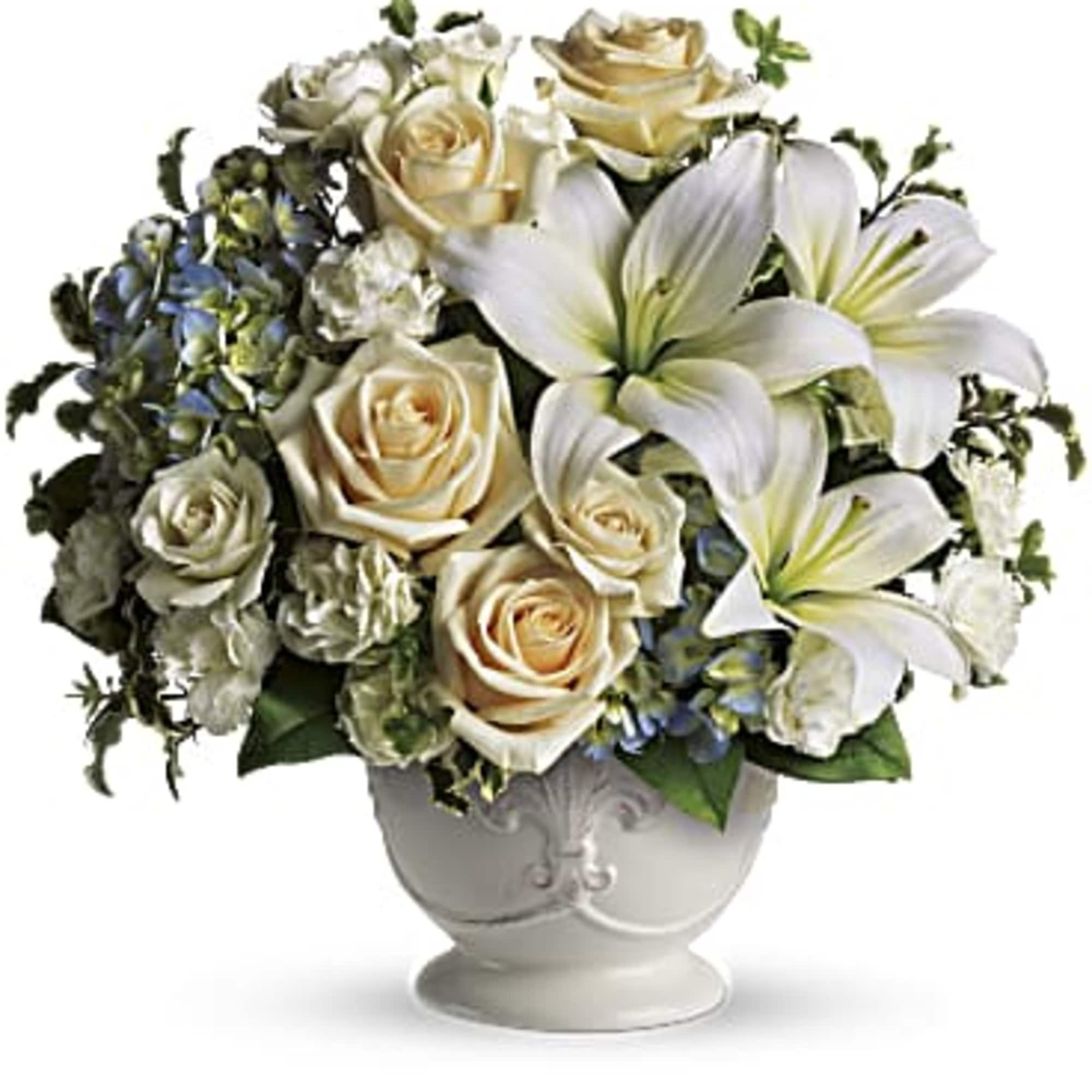 This French country style sympathy arrangement communicates your condolences in a most