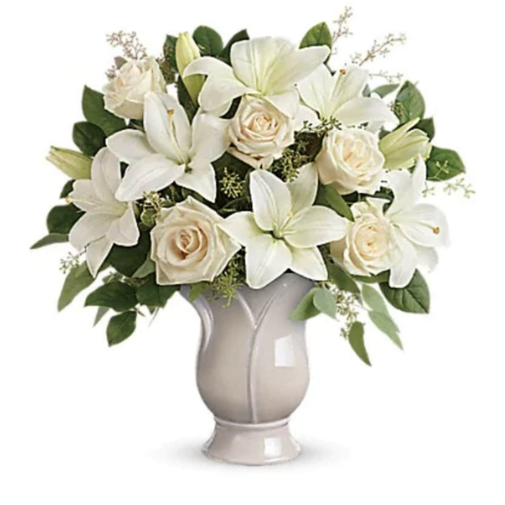 Celebrate a wondrous life with this timeless tribute of pure white lilies