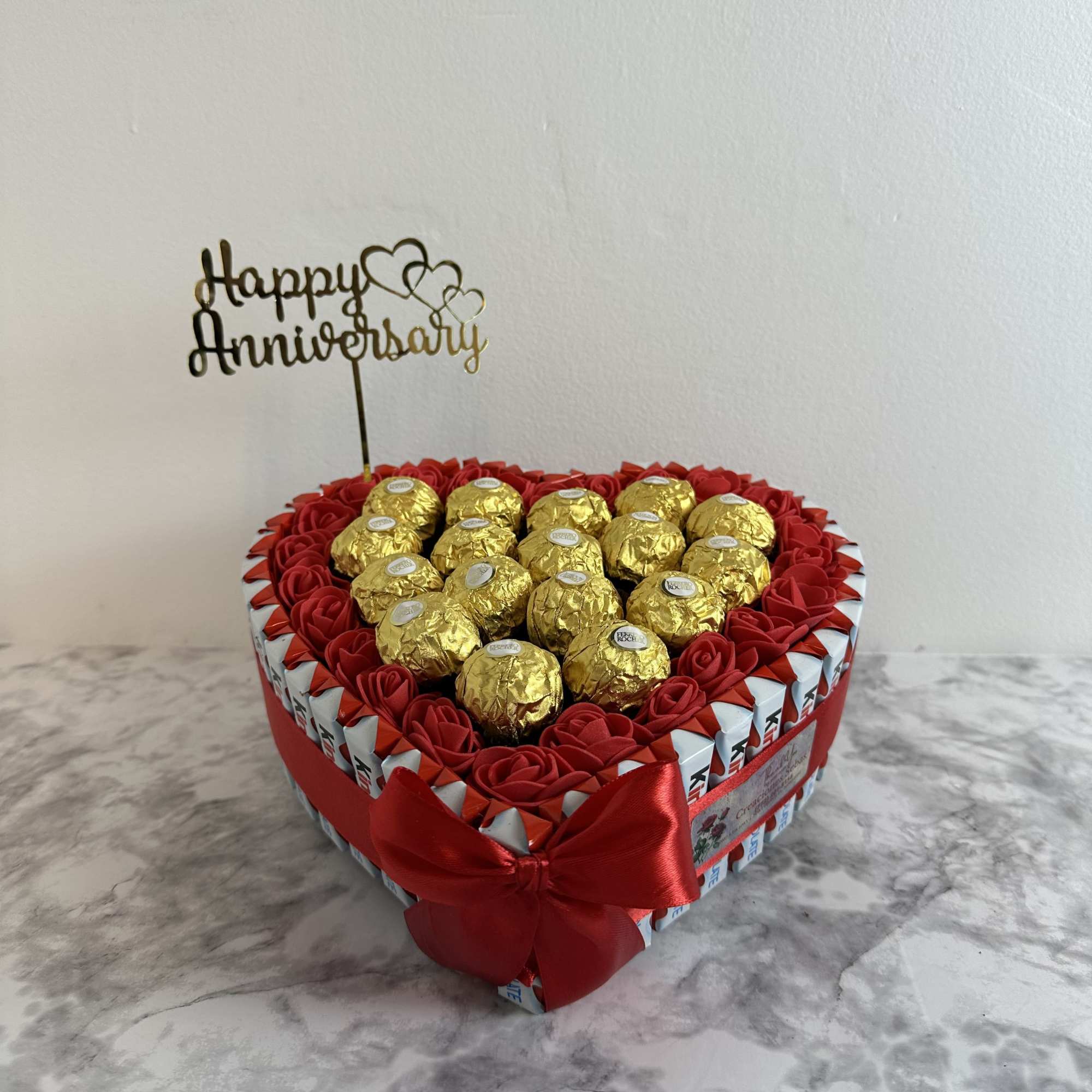 Heart-shaped box of chocolates with Ferrero Rocher and Kinder Bueno, decorated with