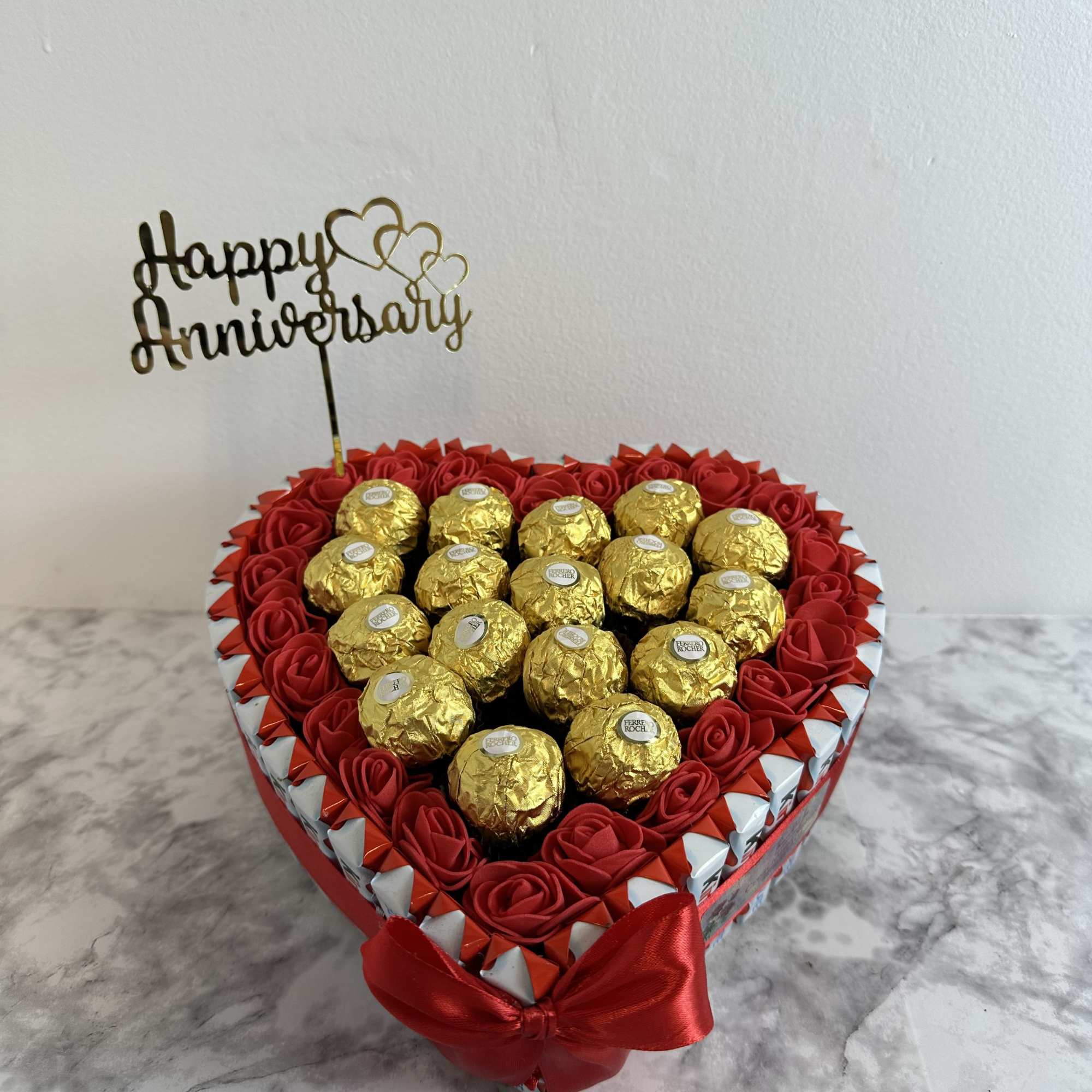 Heart-shaped box of chocolates with Ferrero Rocher and Kinder Bueno, decorated with