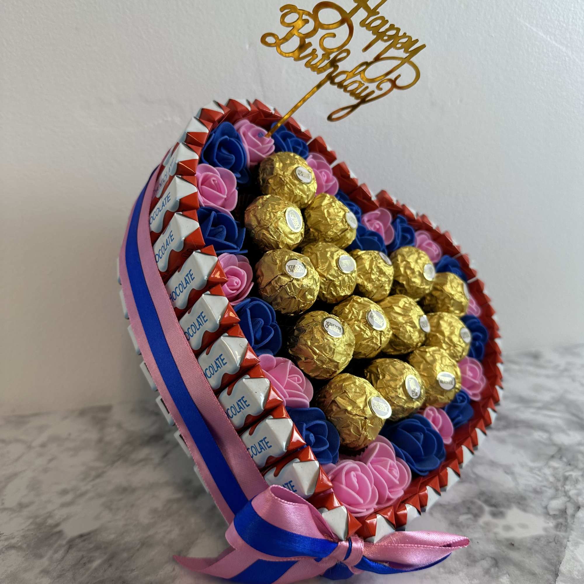 Heart-shaped box of chocolates with Ferrero Rocher and Kinder Bueno, decorated with