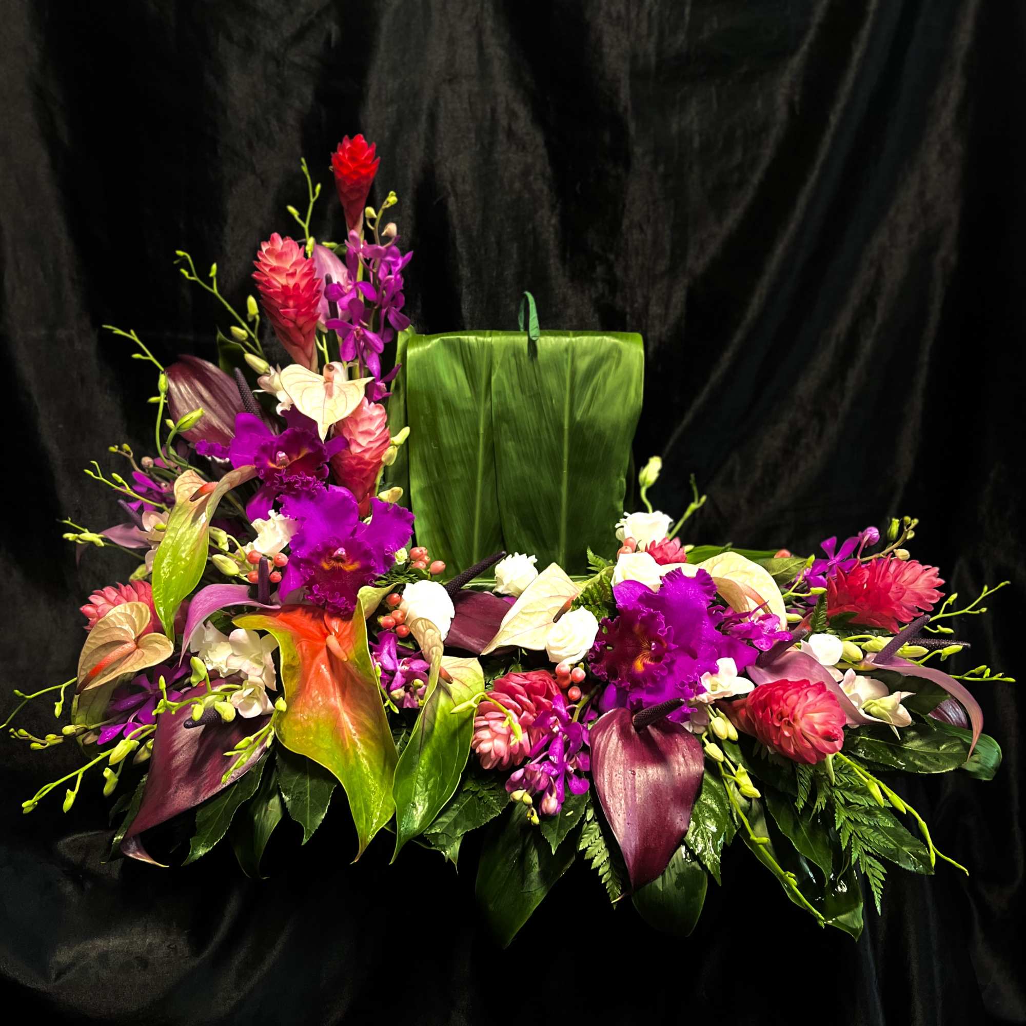 Custom-made tropical riser with platforms for urn and picture frame. 
(Flowers subject