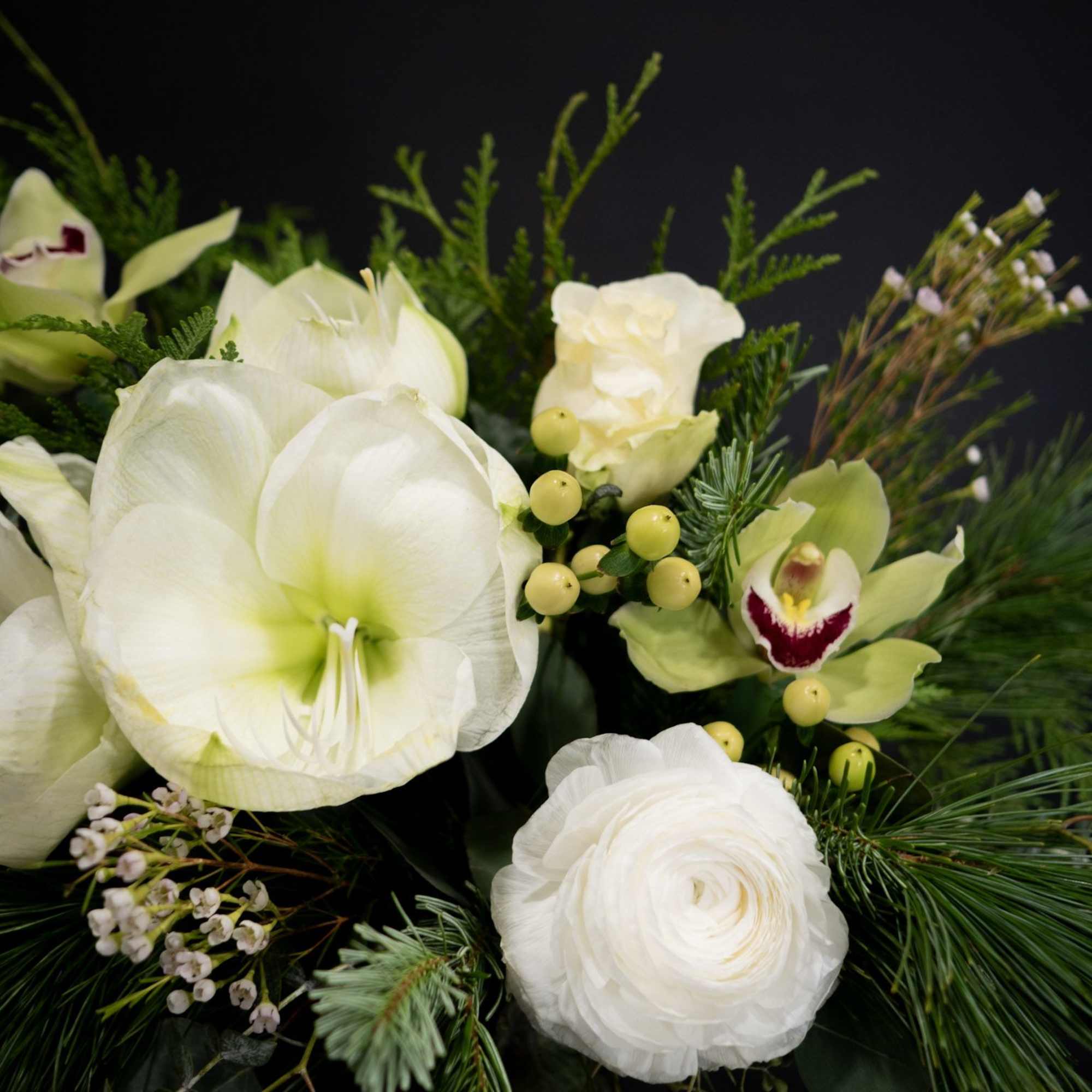 This elegant winter arrangement captures the serene beauty of a snow-dusted landscape.