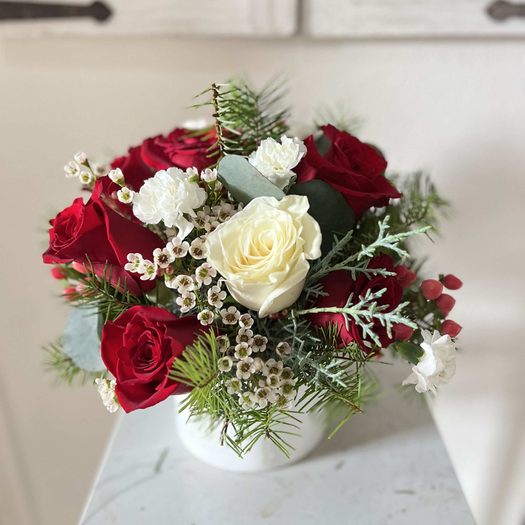 Celebrate the season with Holiday Harmony, a beautifully balanced floral arrangement that