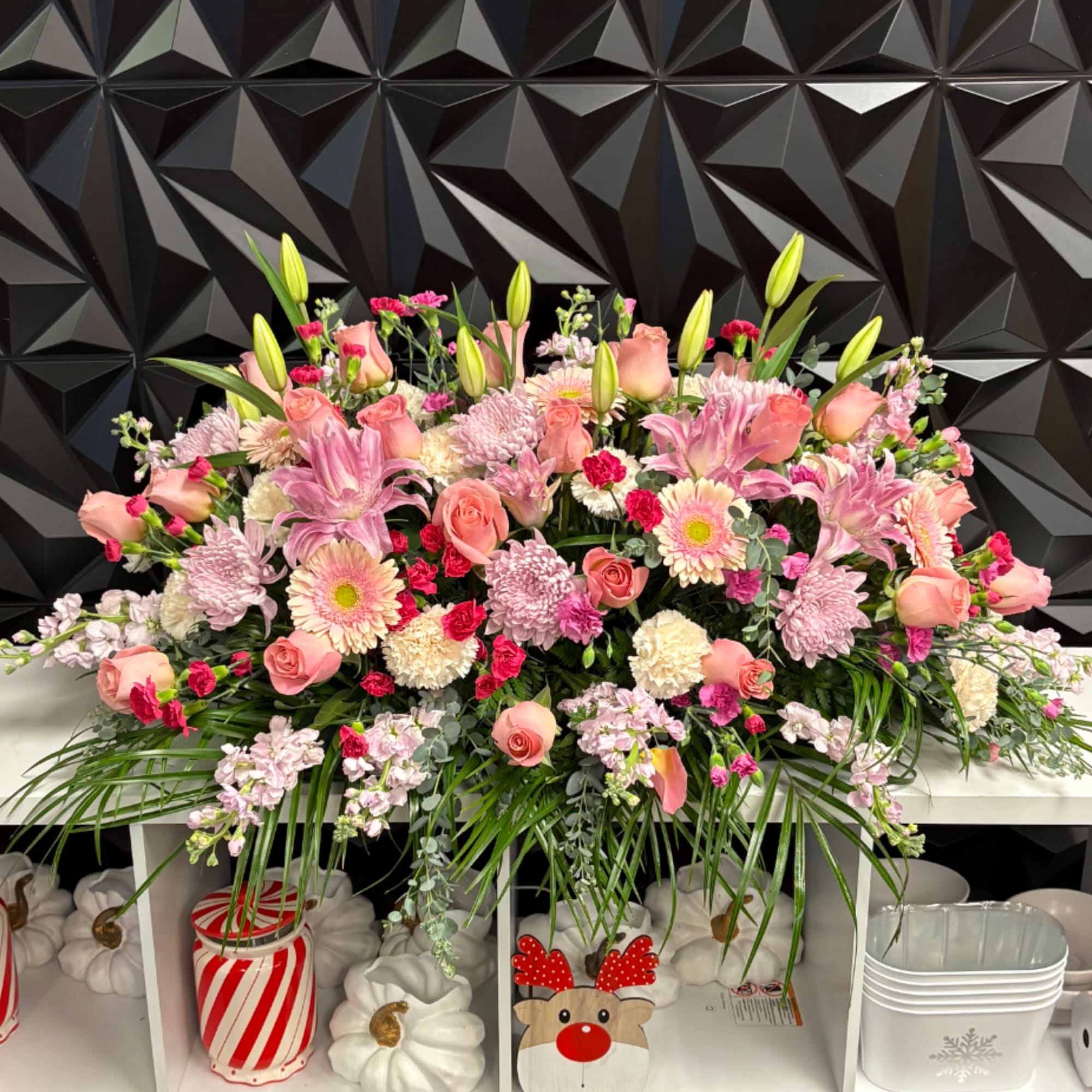 Large pink theme casket spray with mixture of blooms 
