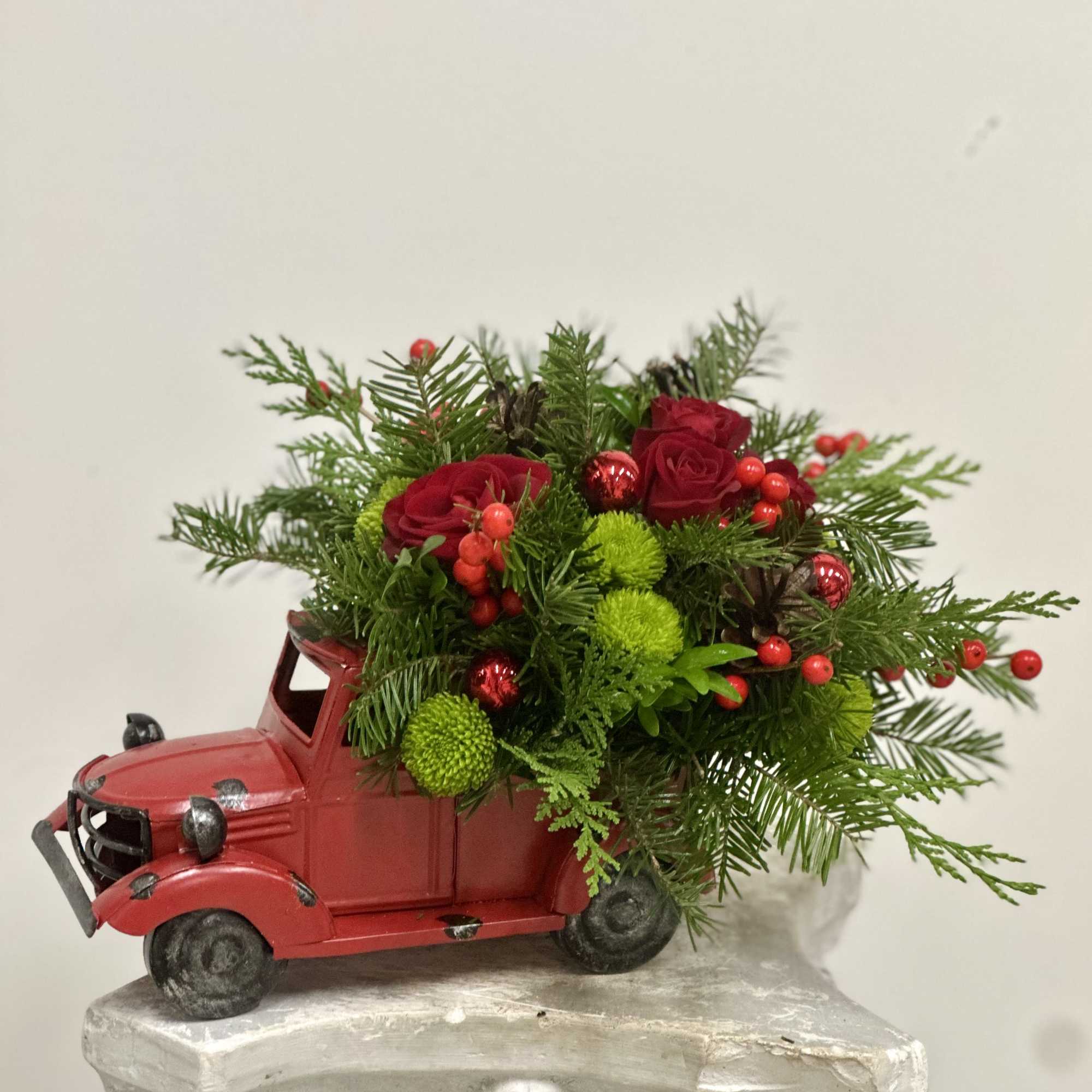 Transform your holiday decor with the Merry and Bright Truck Arrangement by