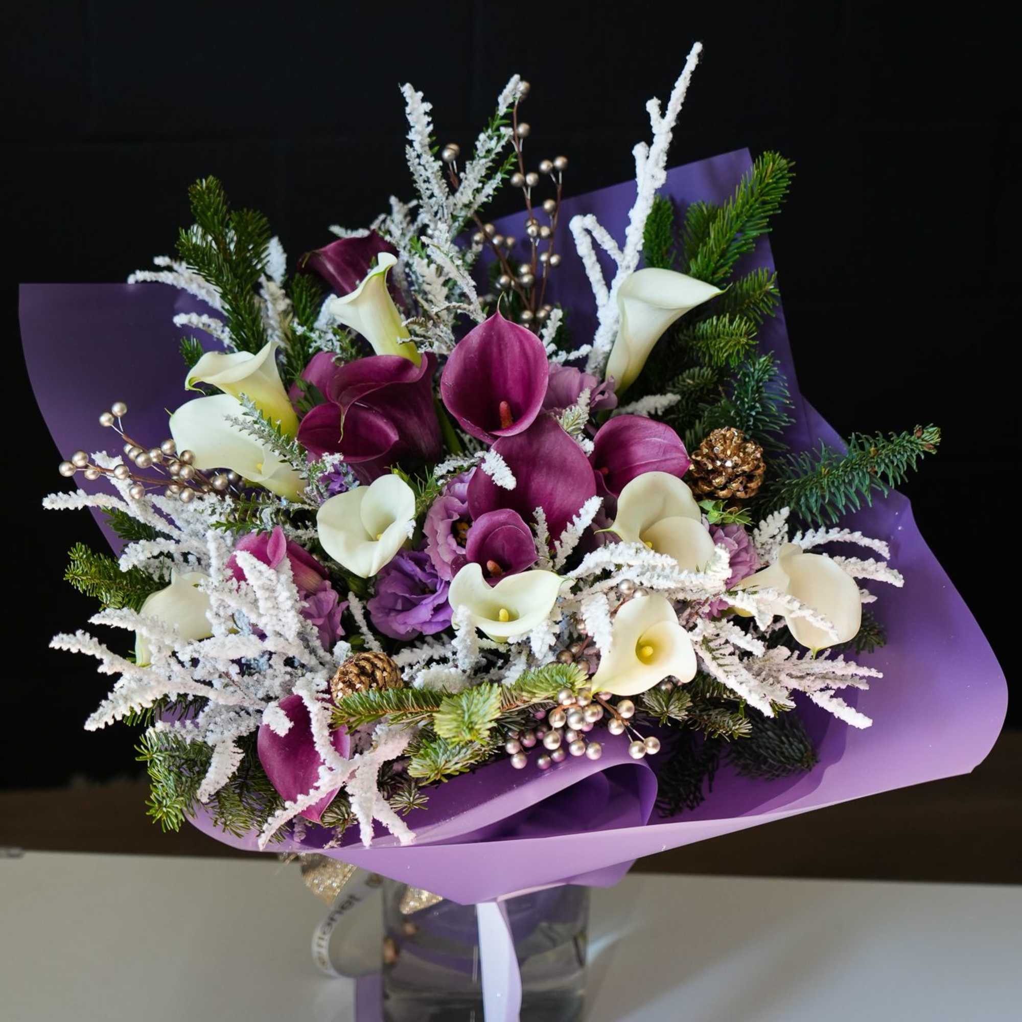 The Amethyst Winter Bouquet is a regal and enchanting arrangement perfect for
