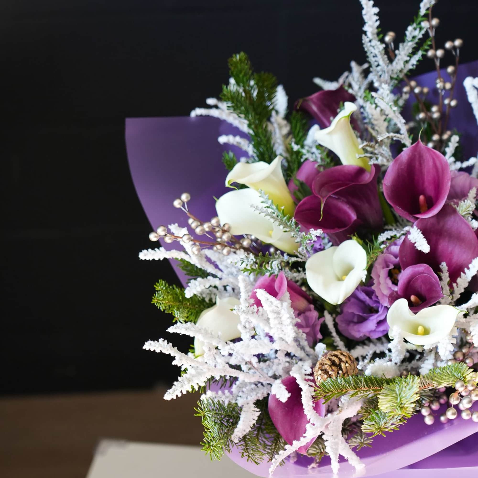 The Amethyst Winter Bouquet is a regal and enchanting arrangement perfect for