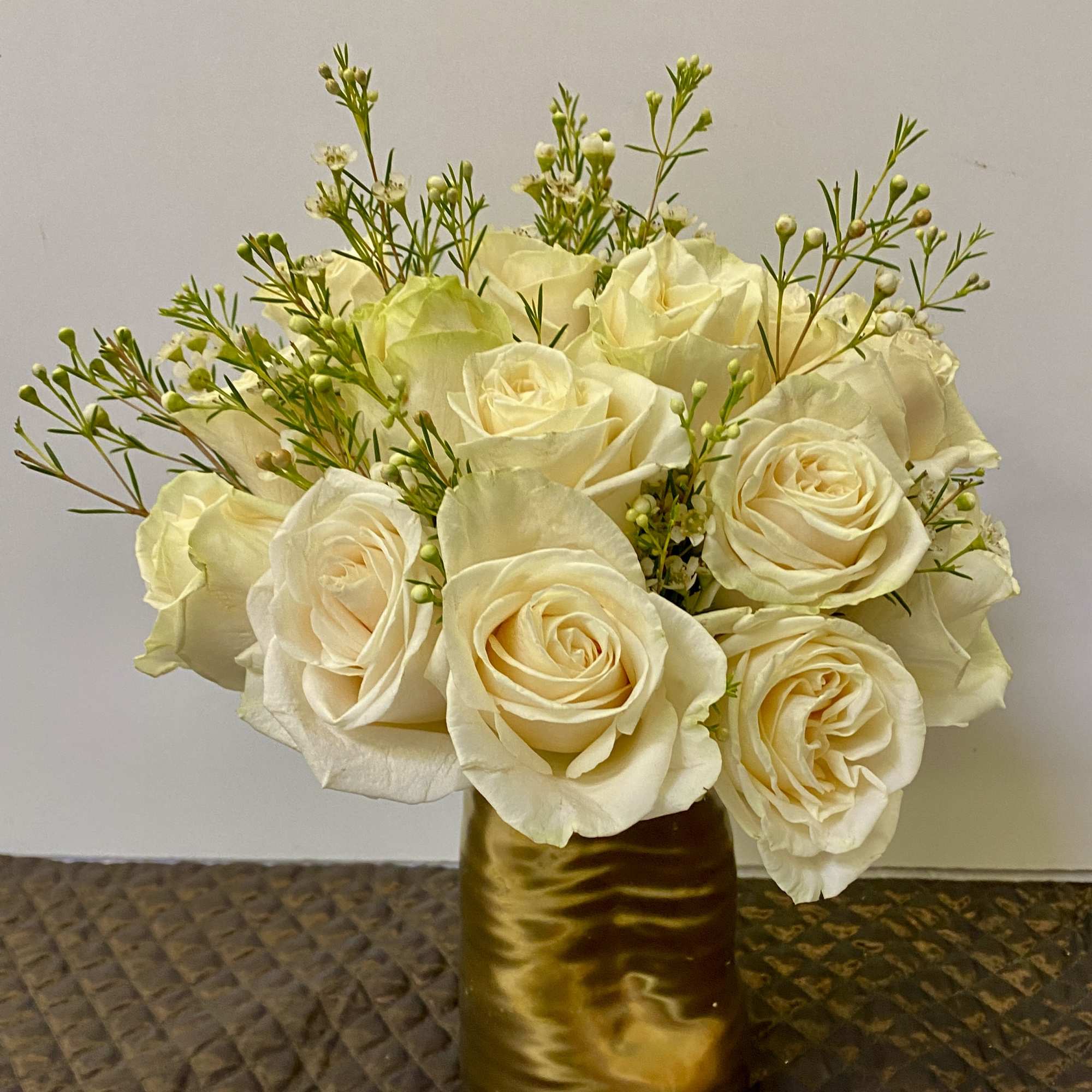 15 white roses in a gold vase 