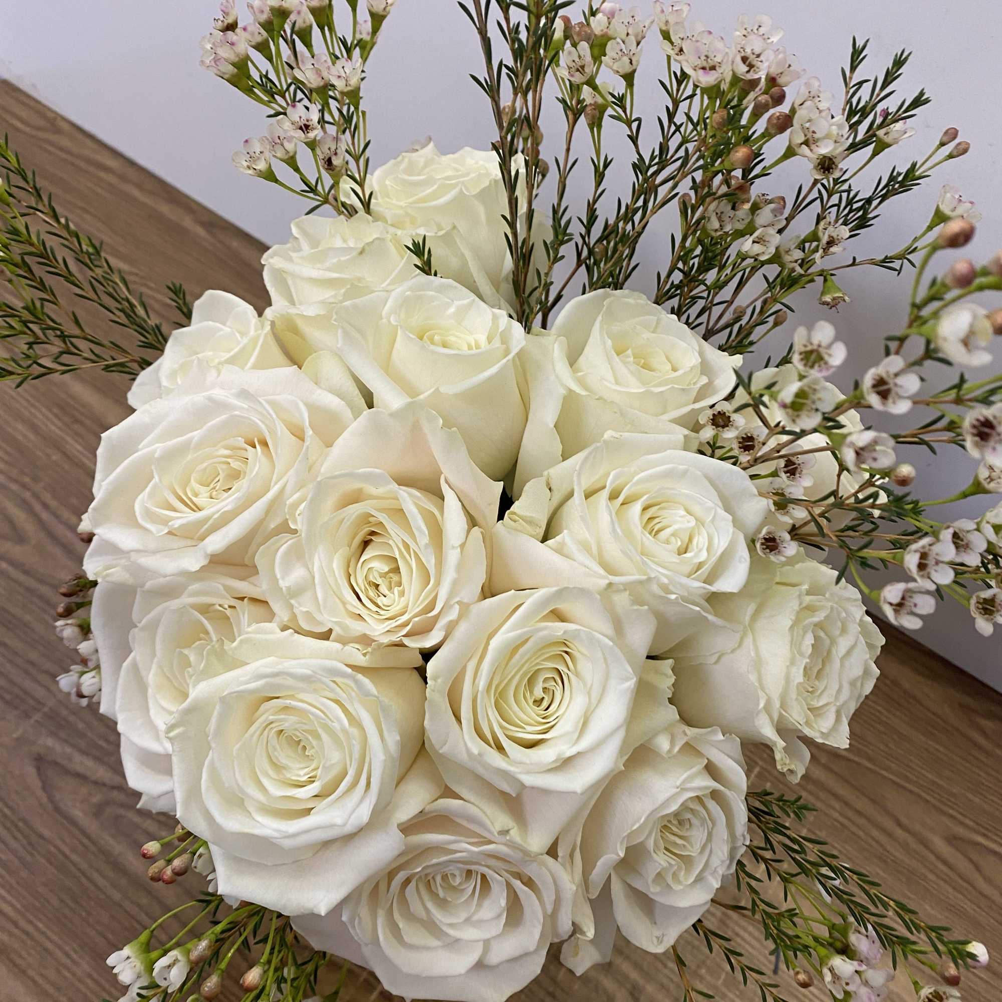 15 white roses in a gold vase 