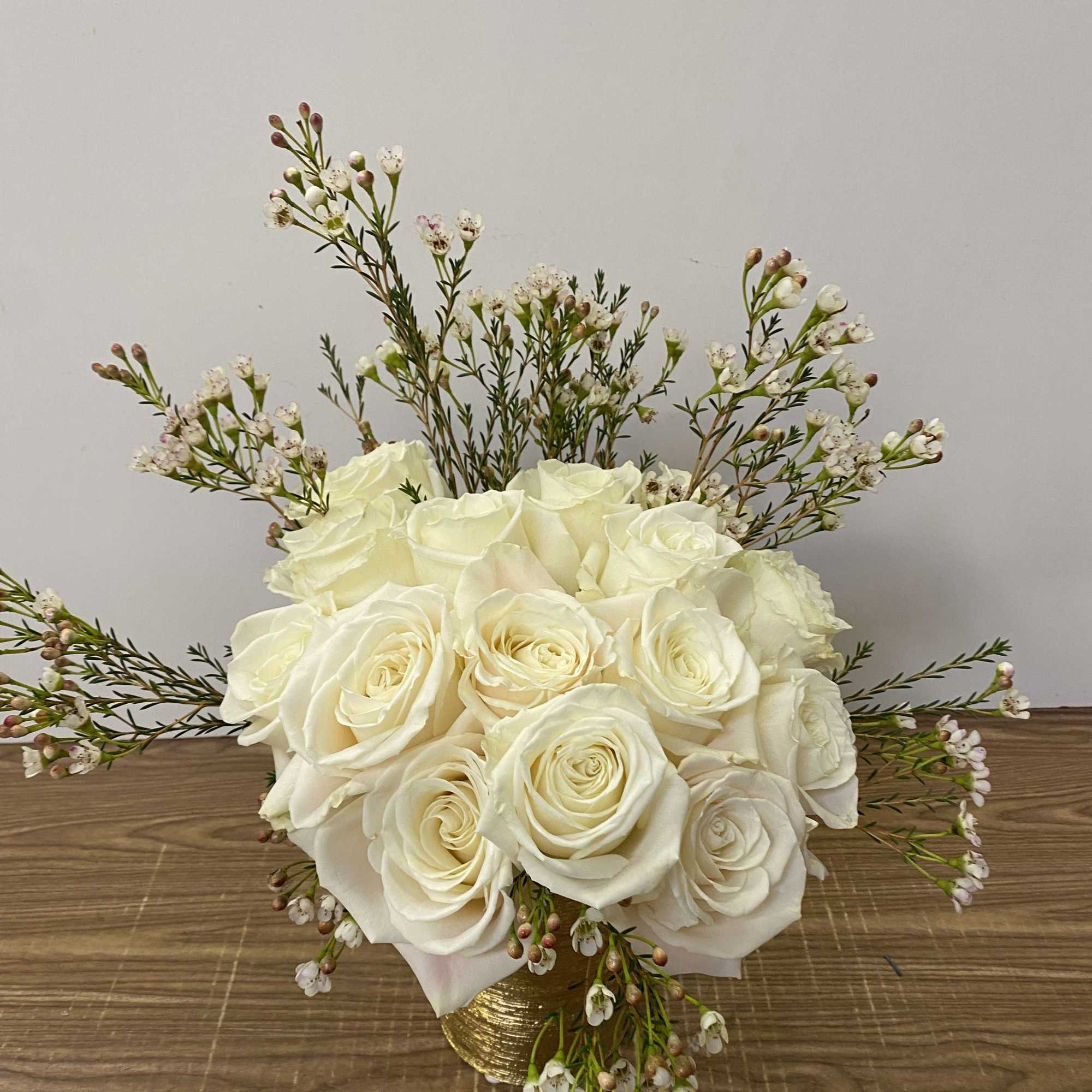 15 white roses in a gold vase 