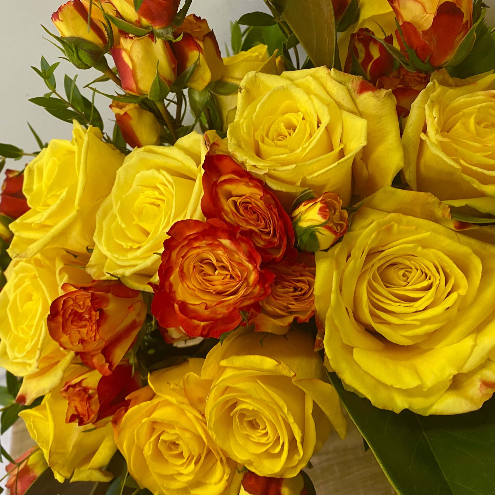 Glass vase with yellow garden roses