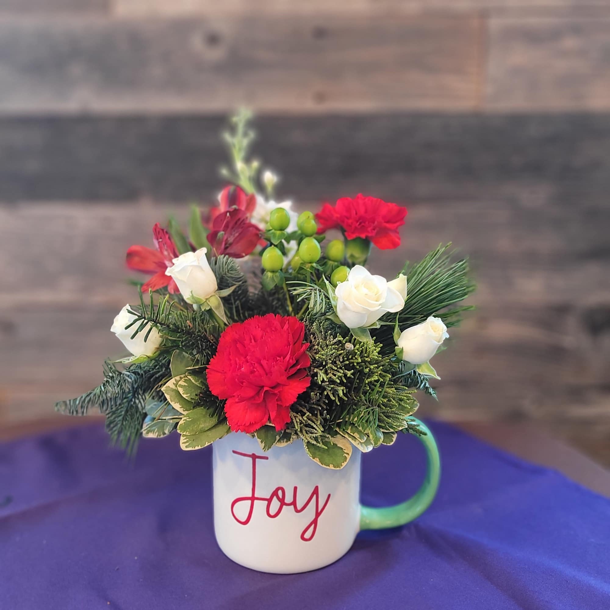 This charming floral arrangement is designed in a keepsake mug and paired