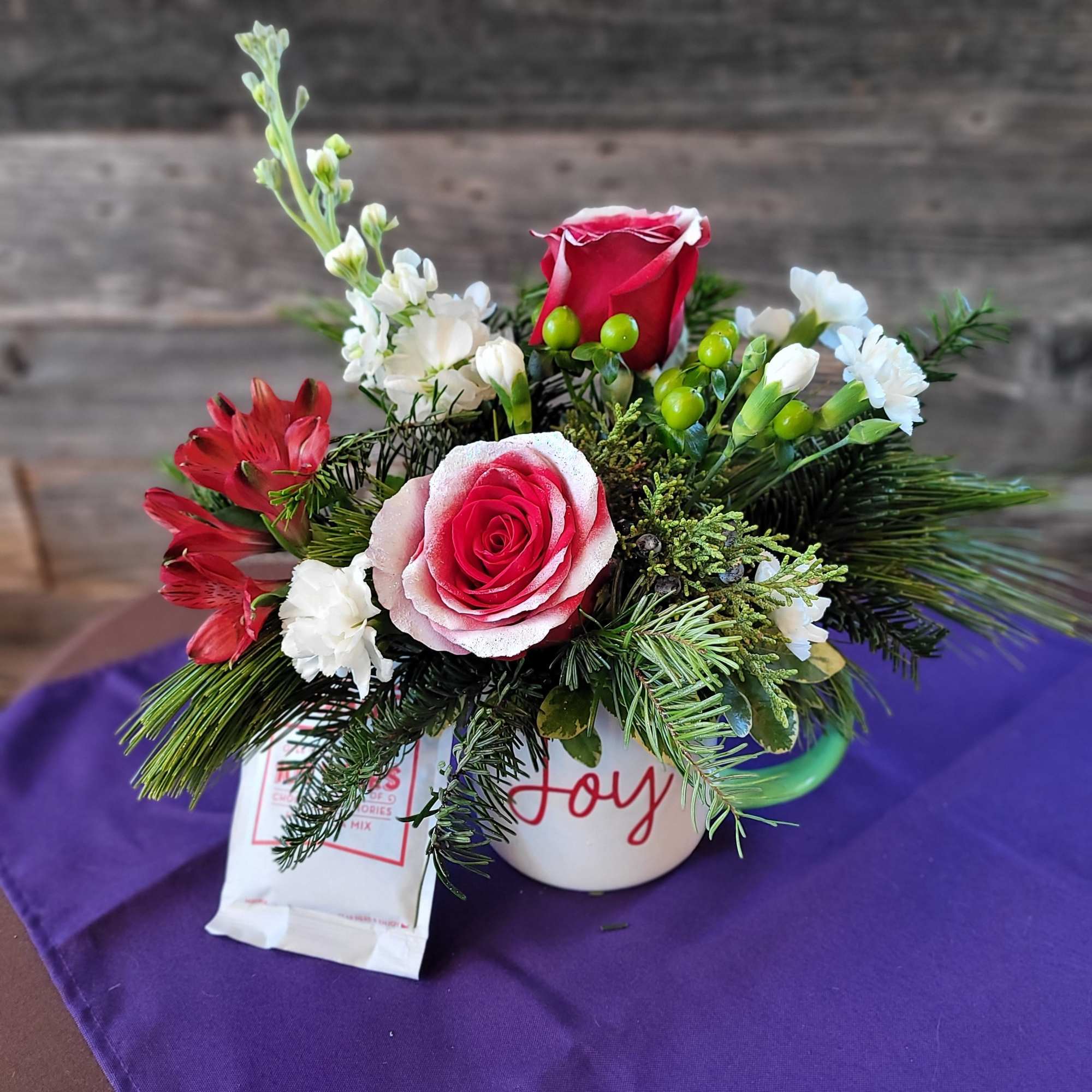 This charming floral arrangement is designed in a keepsake mug and paired