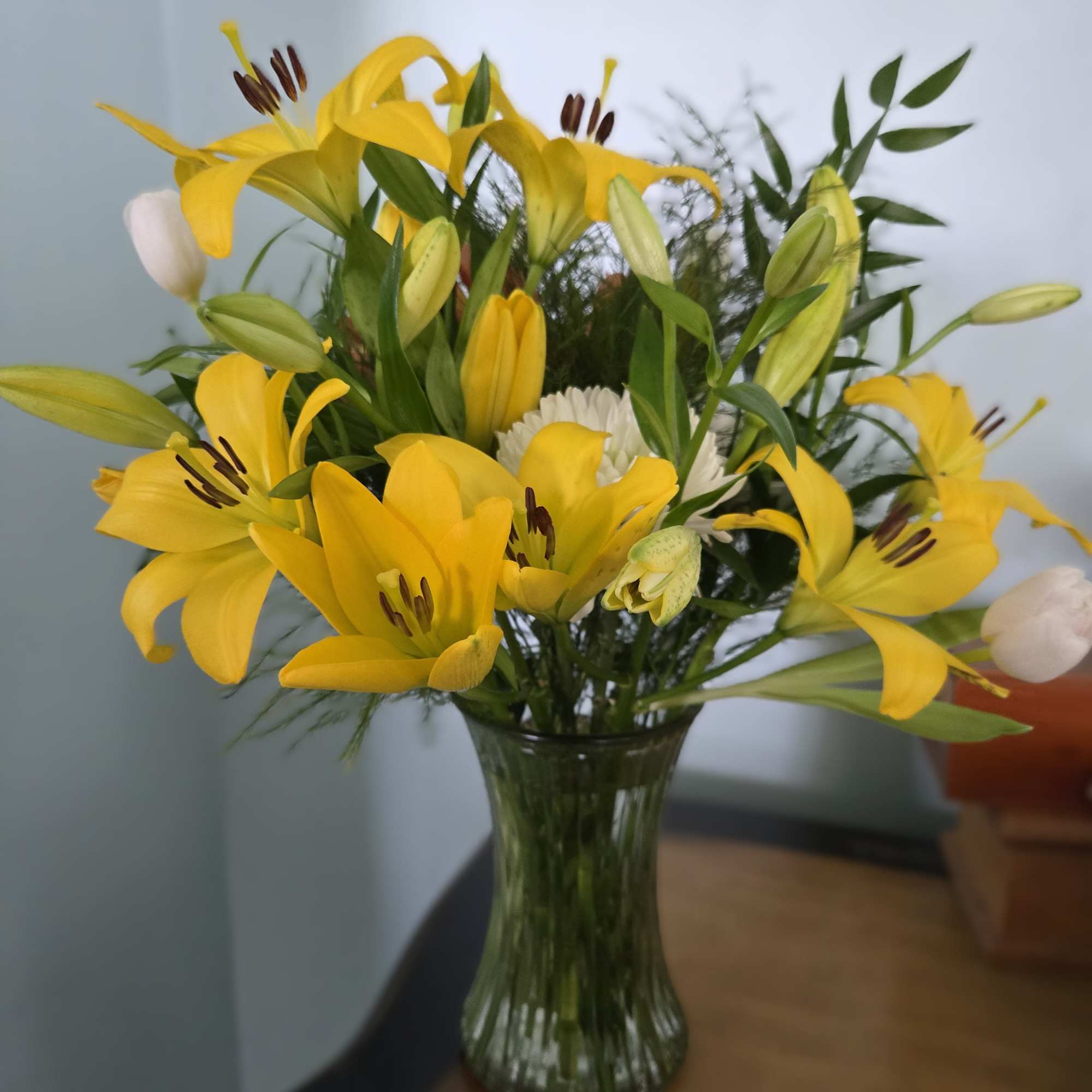 Contains over 12 stems of yellow and white blooms. Displayed in a