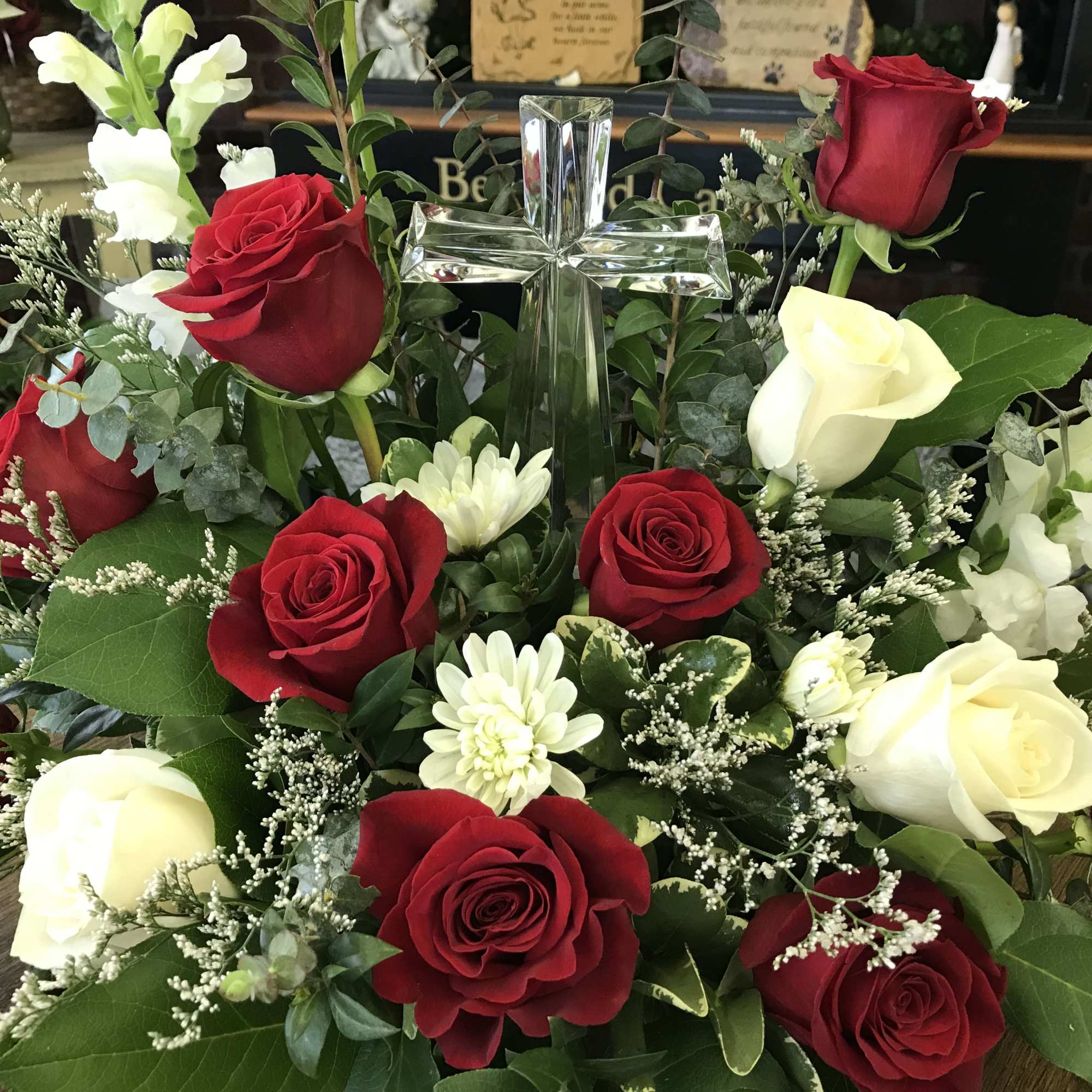 Red roses are featured here in a beautiful sympathy design perfect for