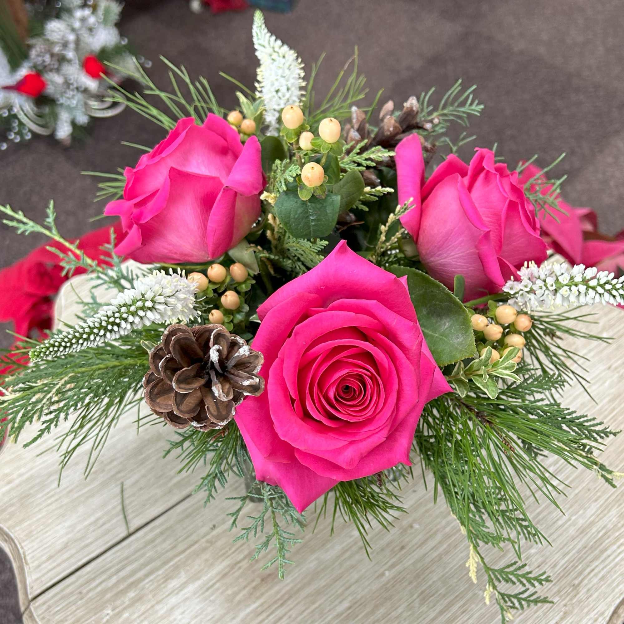 4" Cube with Christmas greens, hot pink roses, veronica, hypericum berries, and
