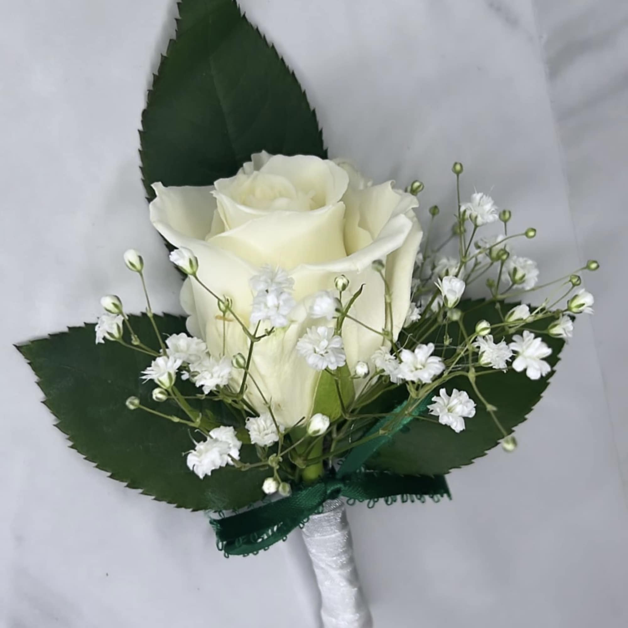 A classic white boutonni&egrave;re that compliments any suit. A perfect addition for