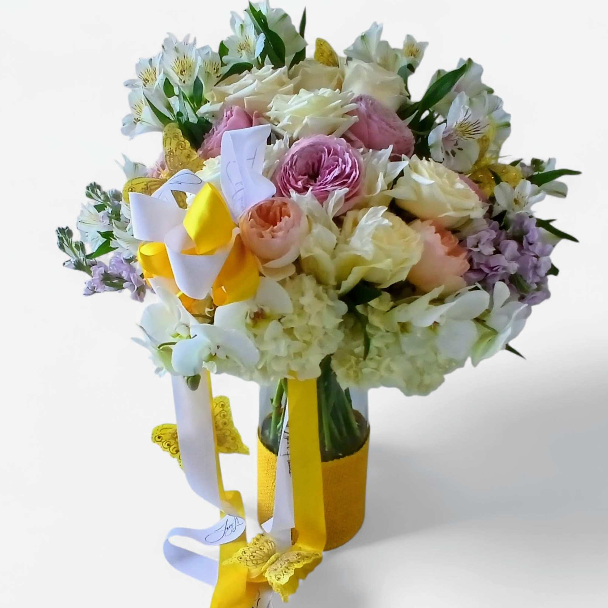 Lovely roses orchids and so much more arranged in a modern glass