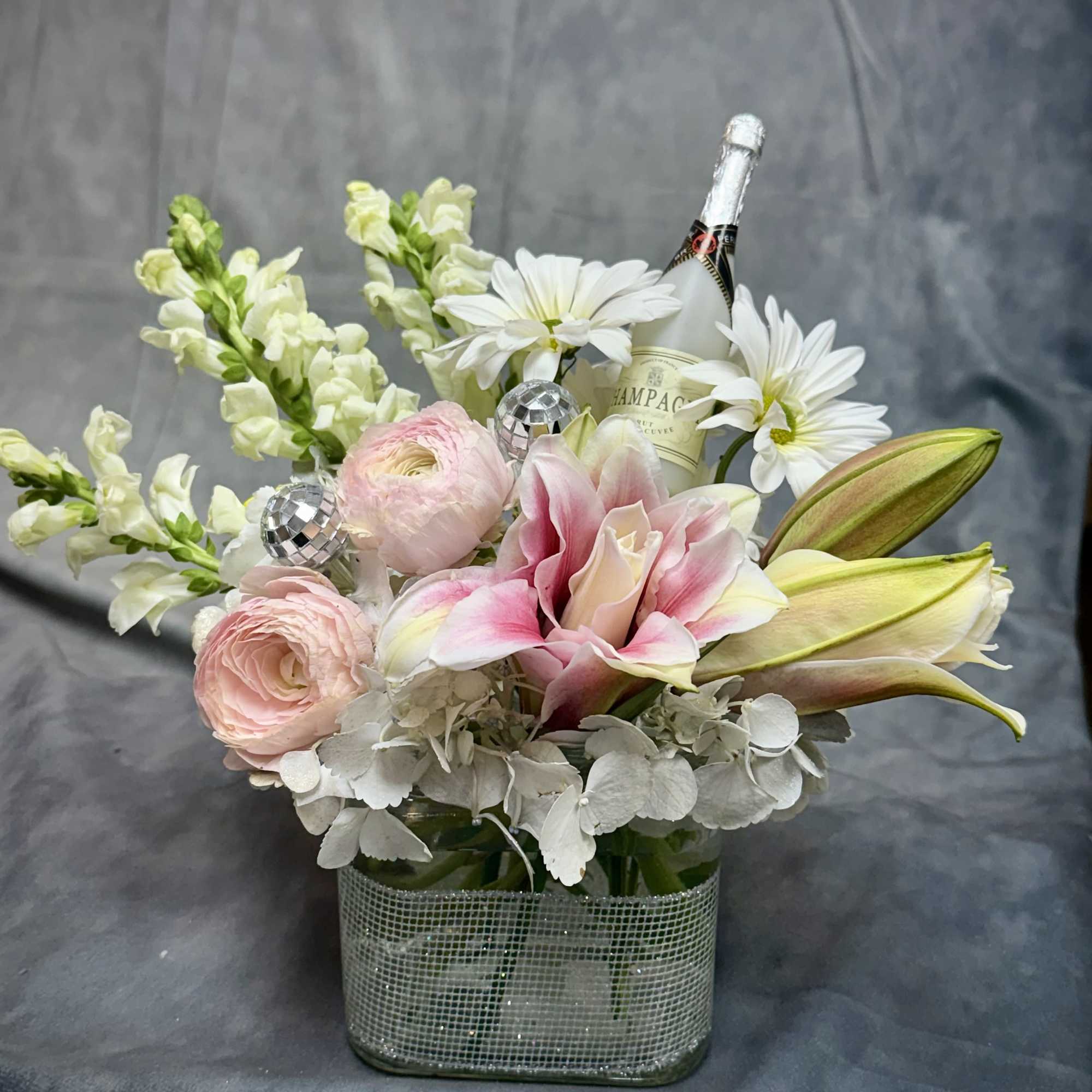 Delicate florals in pastel pink and ivory paired with subtle shimmer and