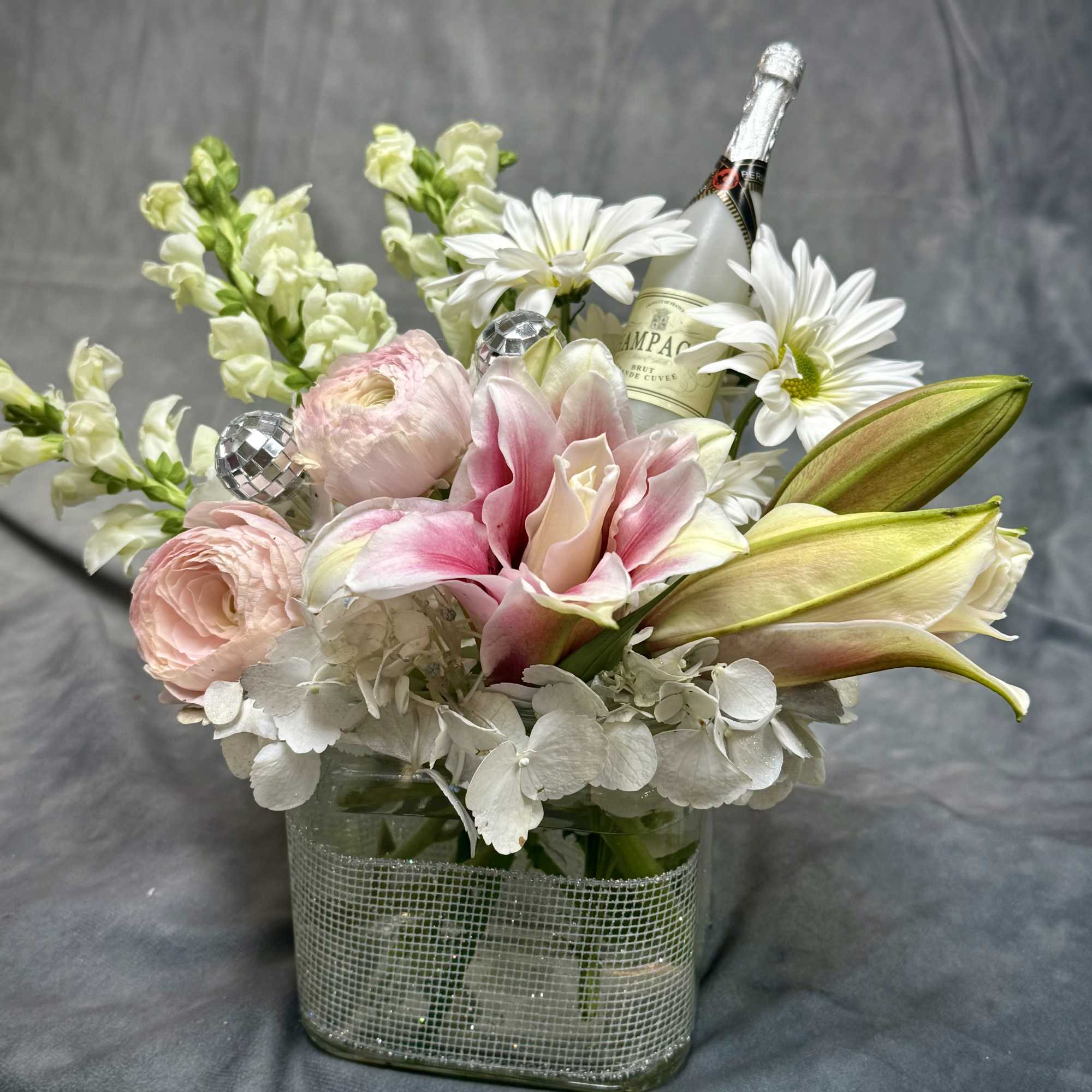 Delicate florals in pastel pink and ivory paired with subtle shimmer and