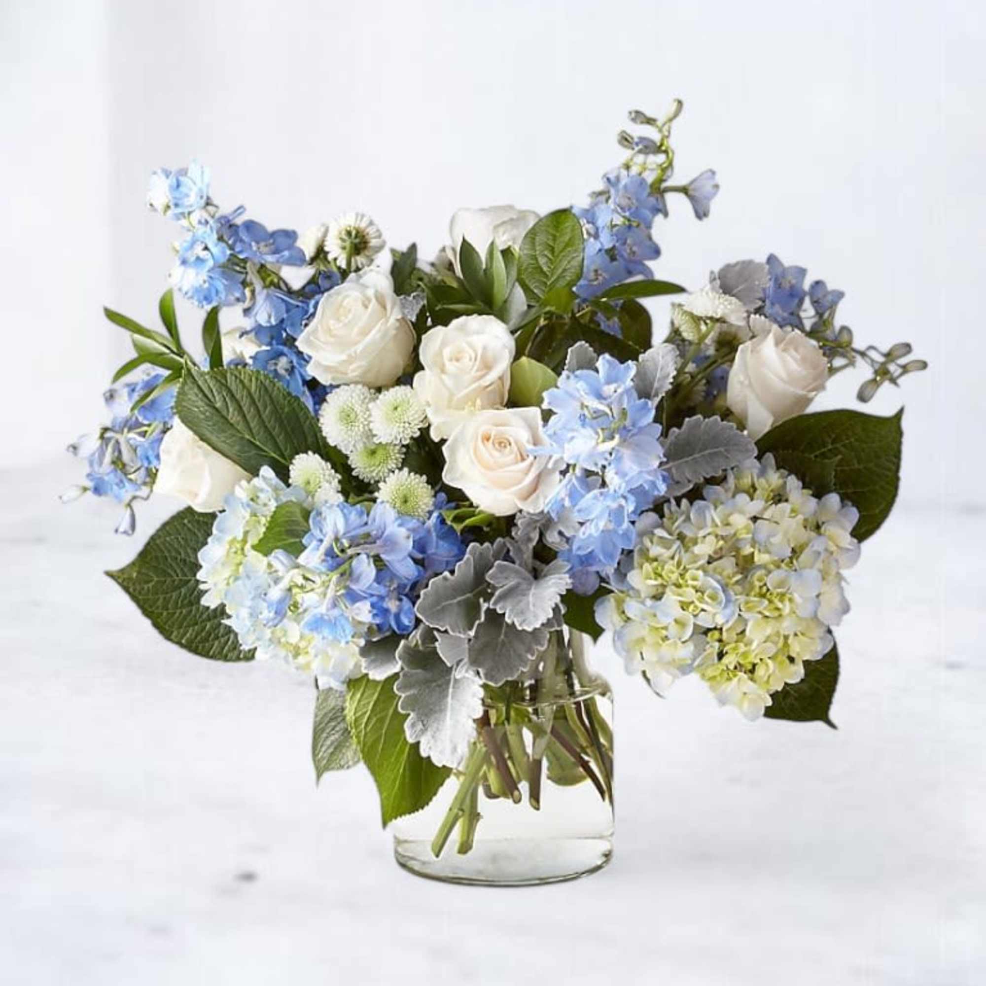 The Serenity Blue Bouquet is a breathtaking arrangement of soft white roses