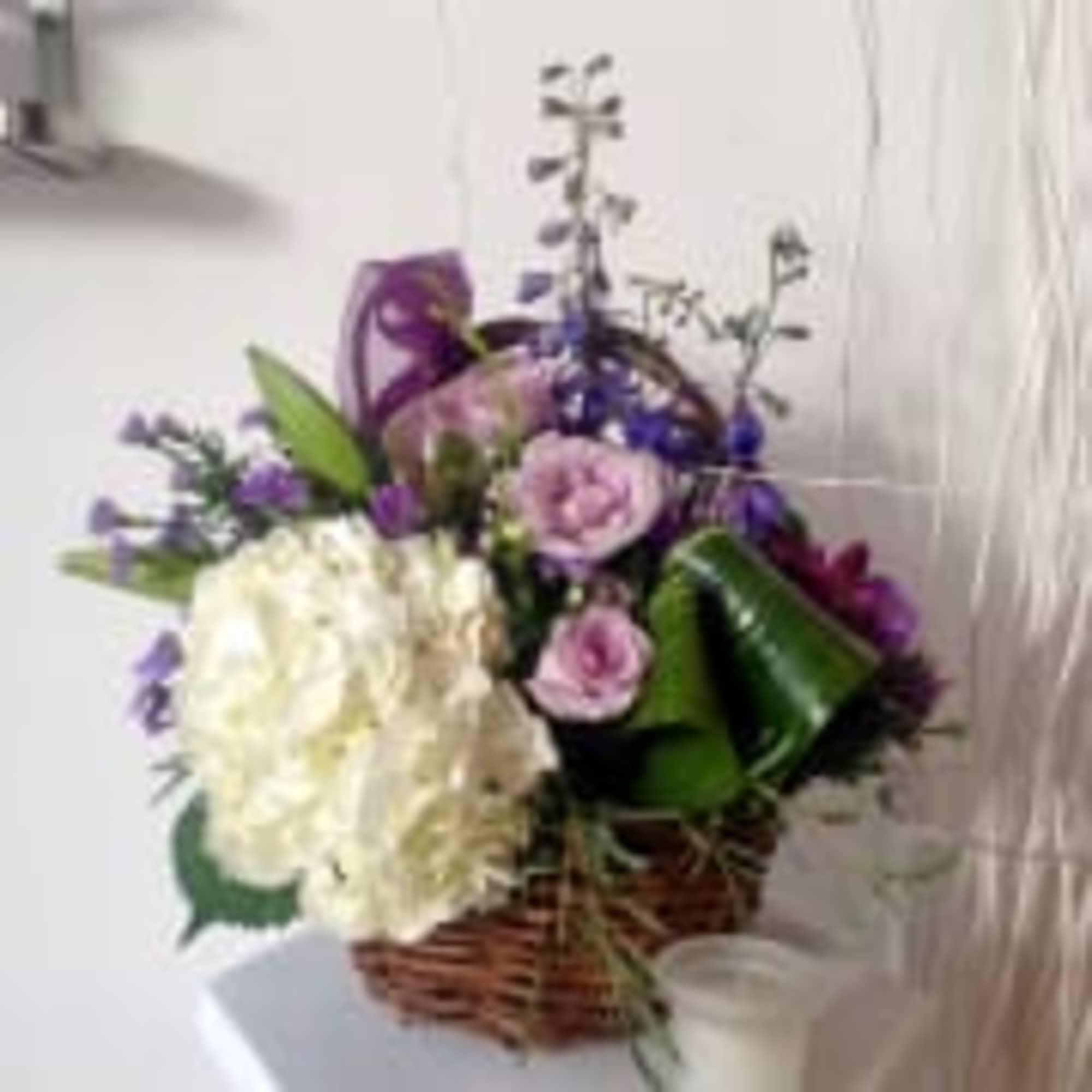 Lavender and lovely, our fresh-packed basket features roses, hydrangeas, daisies, alstroemeria, mums