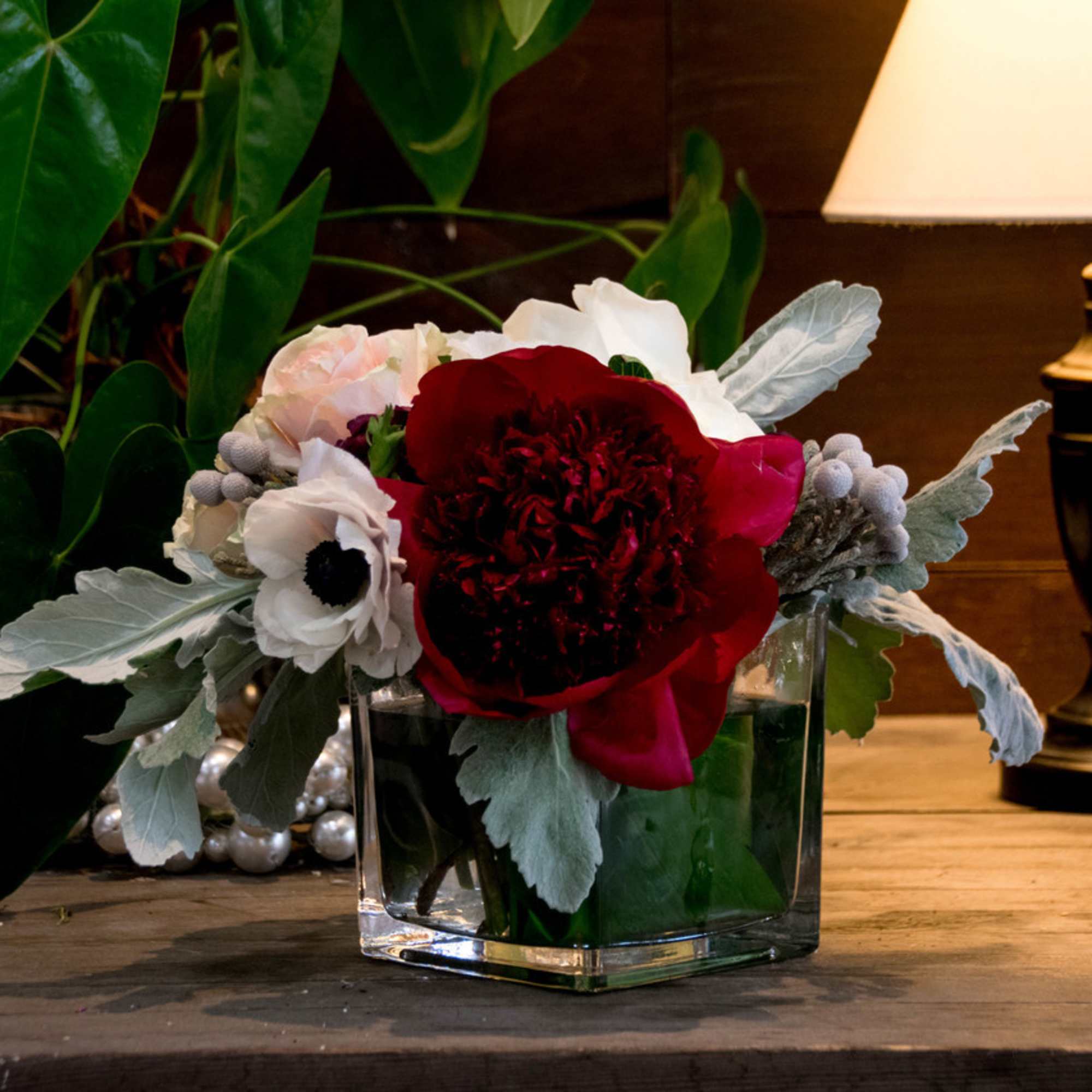 This beauty is designed with soft pink roses, white anemones, dark red