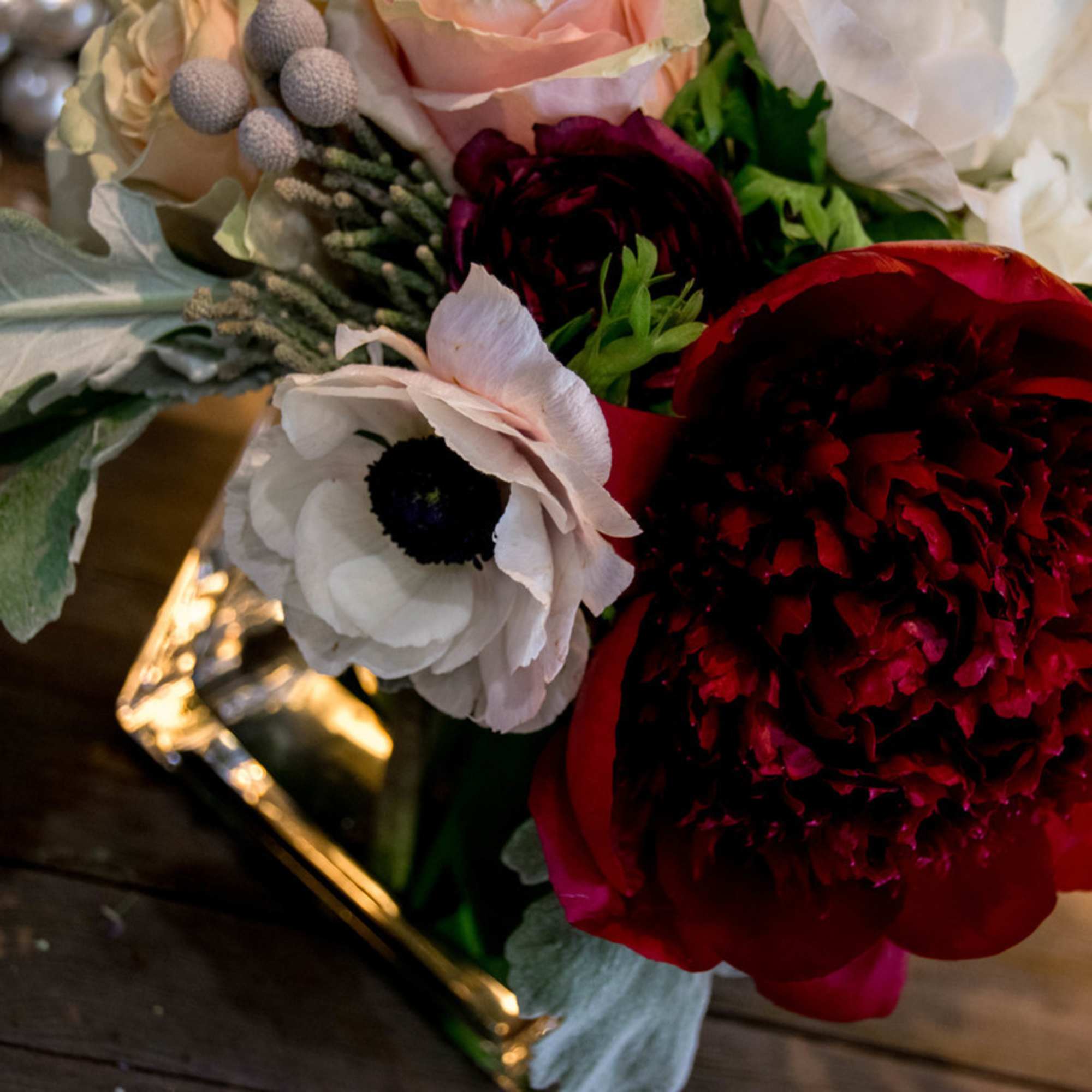 This beauty is designed with soft pink roses, white anemones, dark red