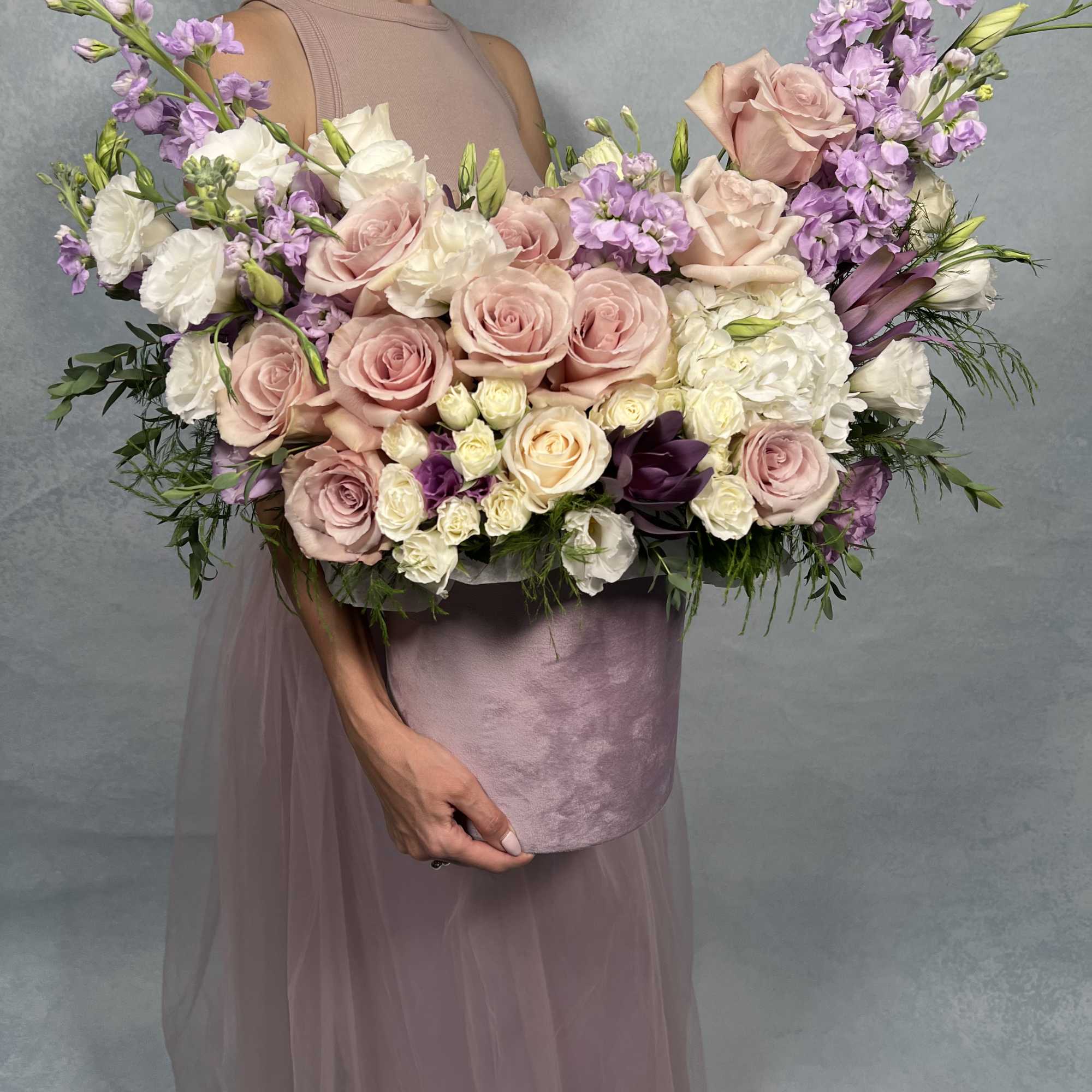This elegant floral arrangement features a soft palette of blush pink roses