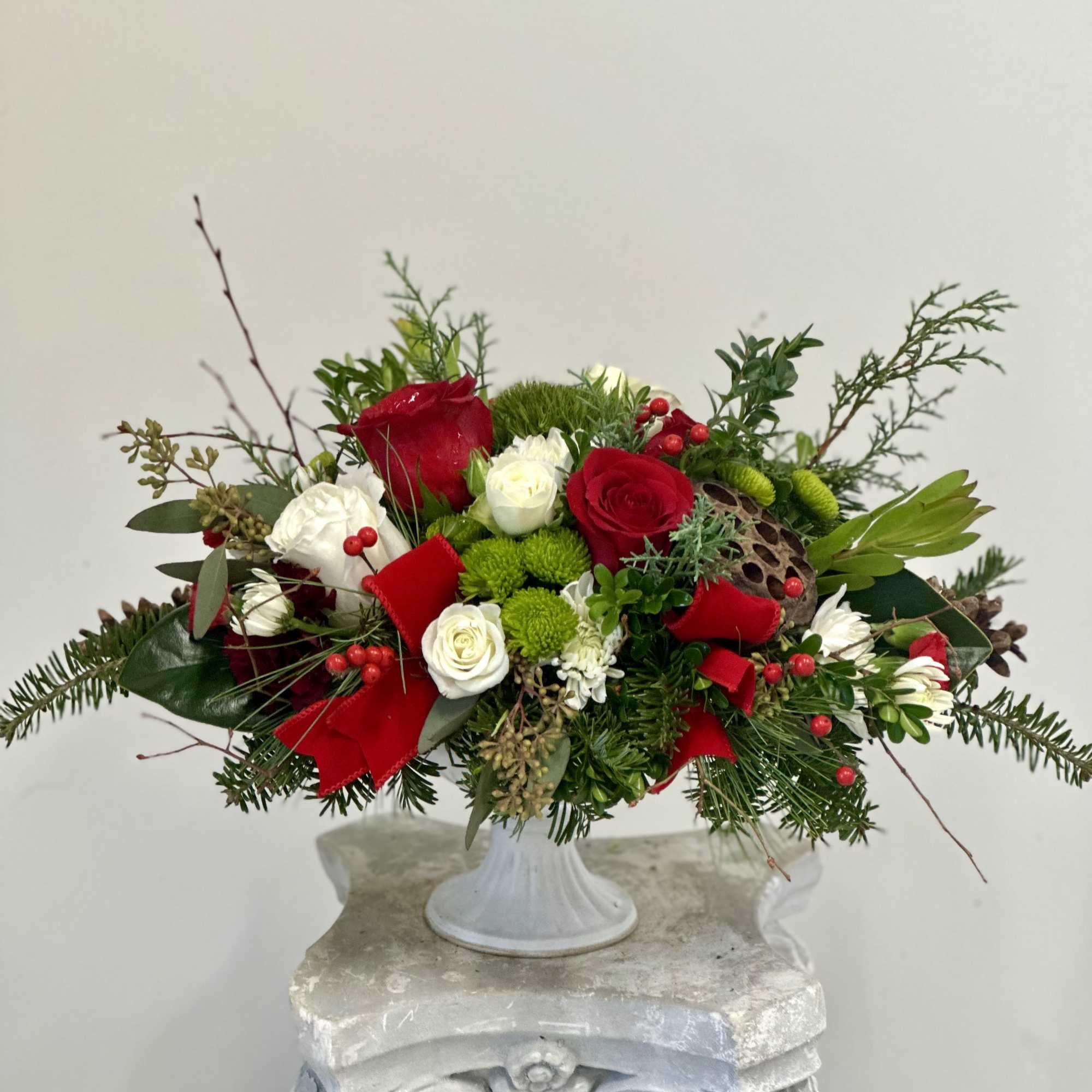Elevate your holiday gatherings with the Holiday Harmony Centerpiece by Westford Florist.