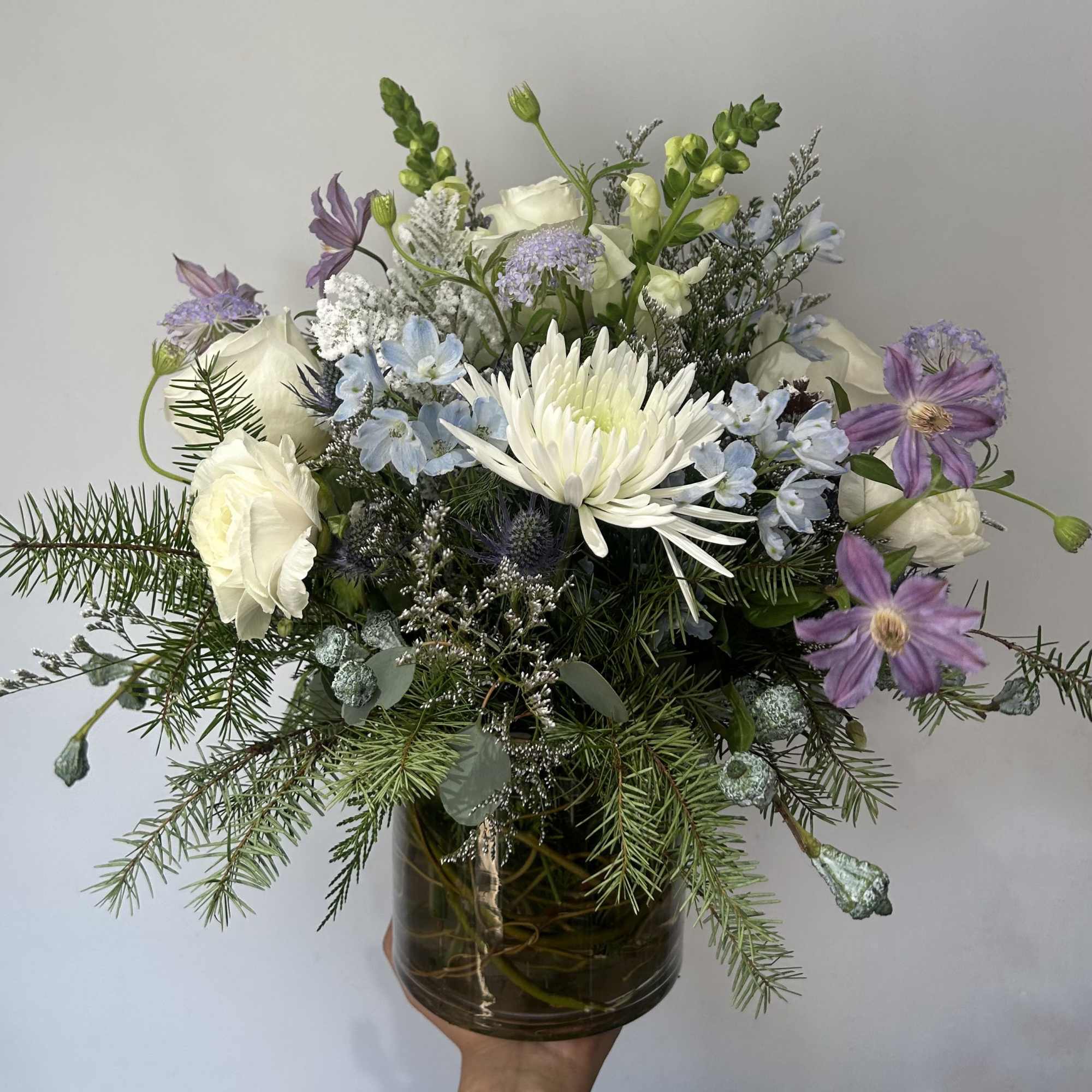 Seasonal winter flowers arranged into a vase. 