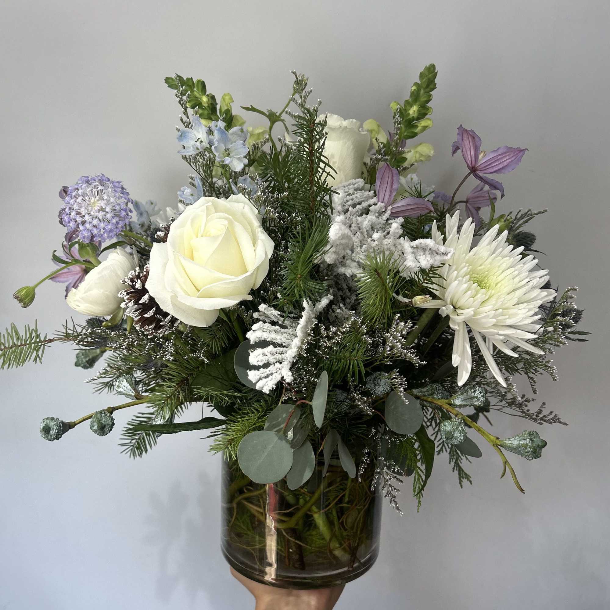 Seasonal winter flowers arranged into a vase. 